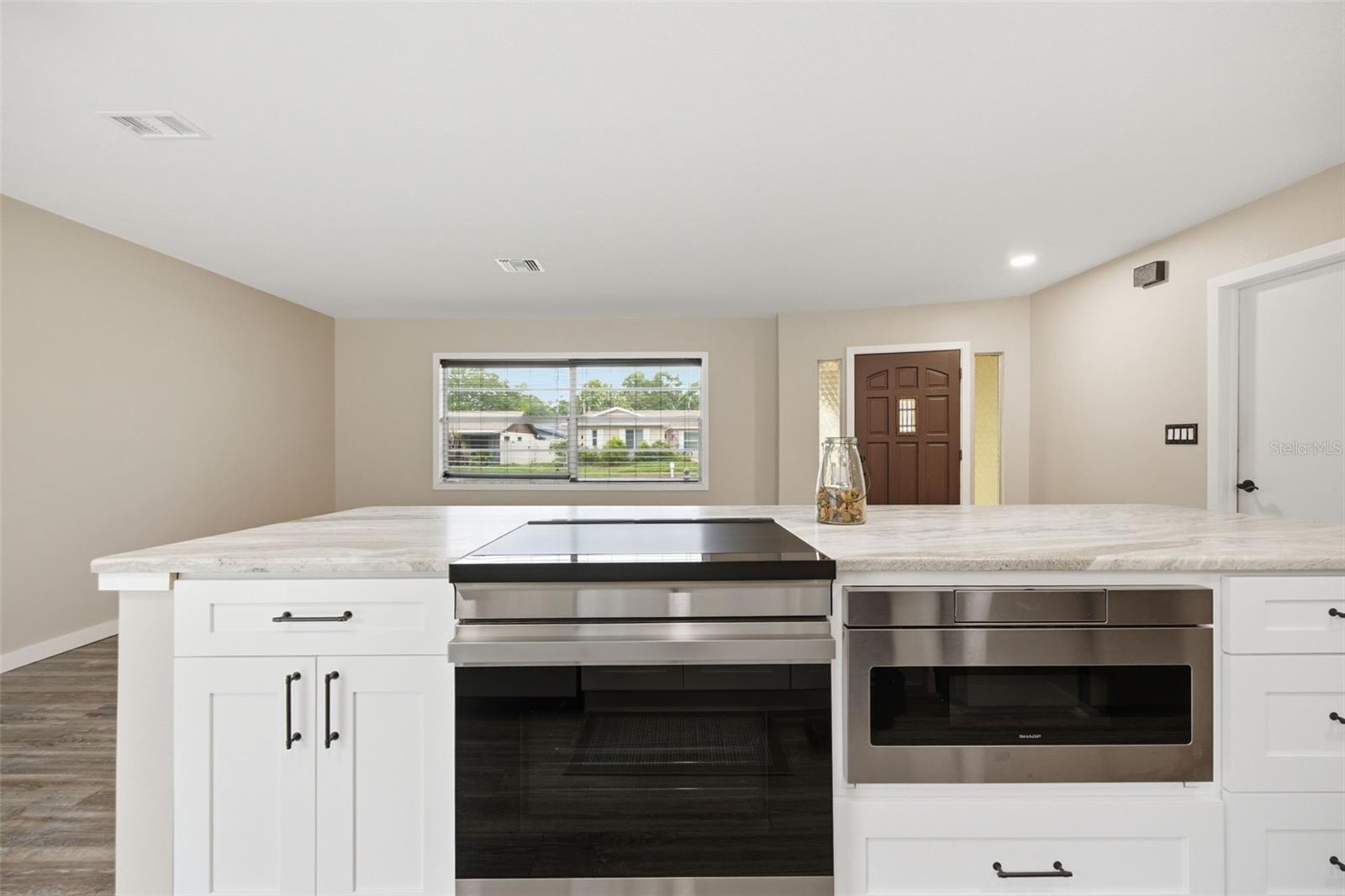 Kitchen island with stone counters & microwave