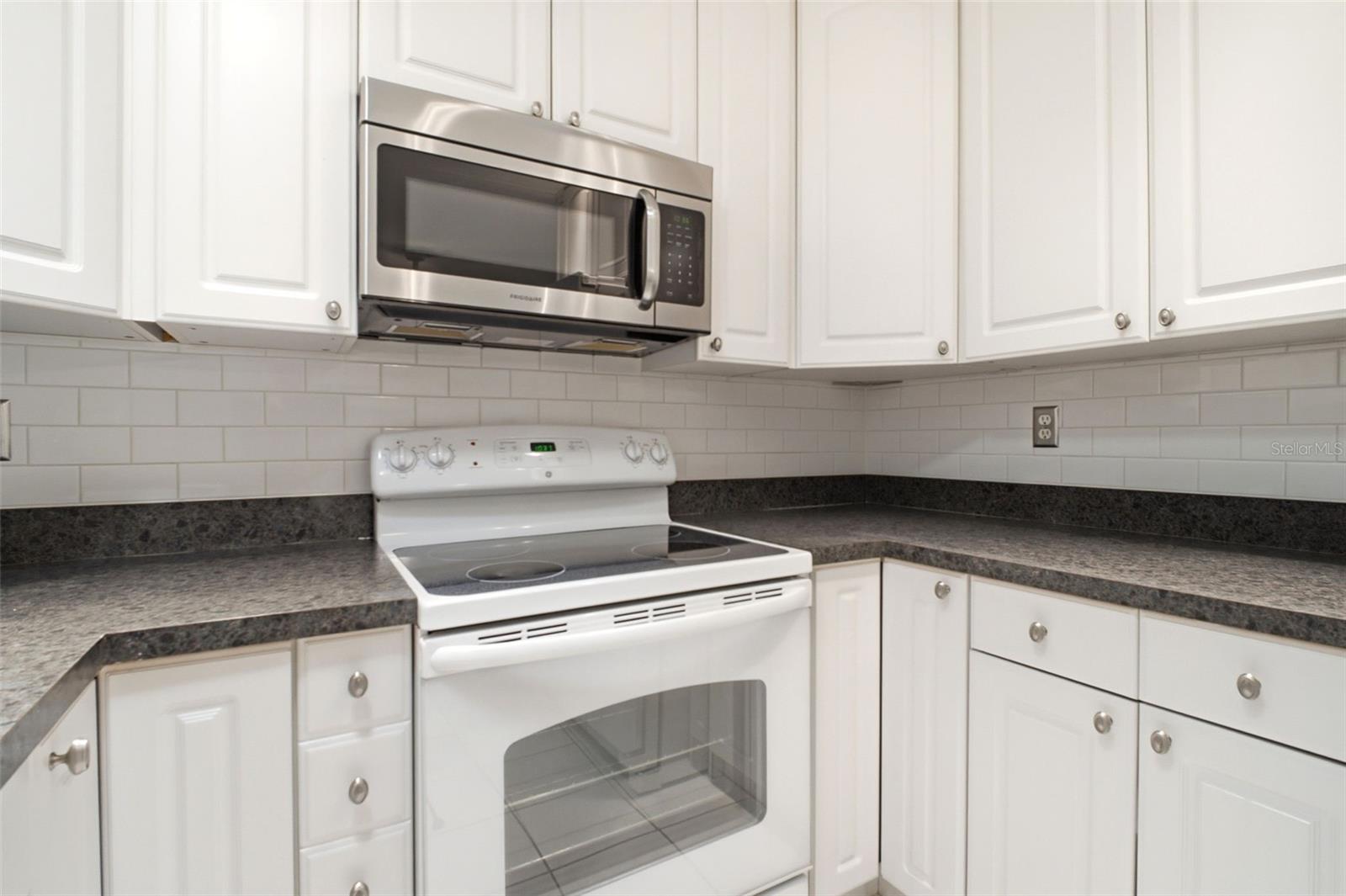Abundant cabinets and counter space~