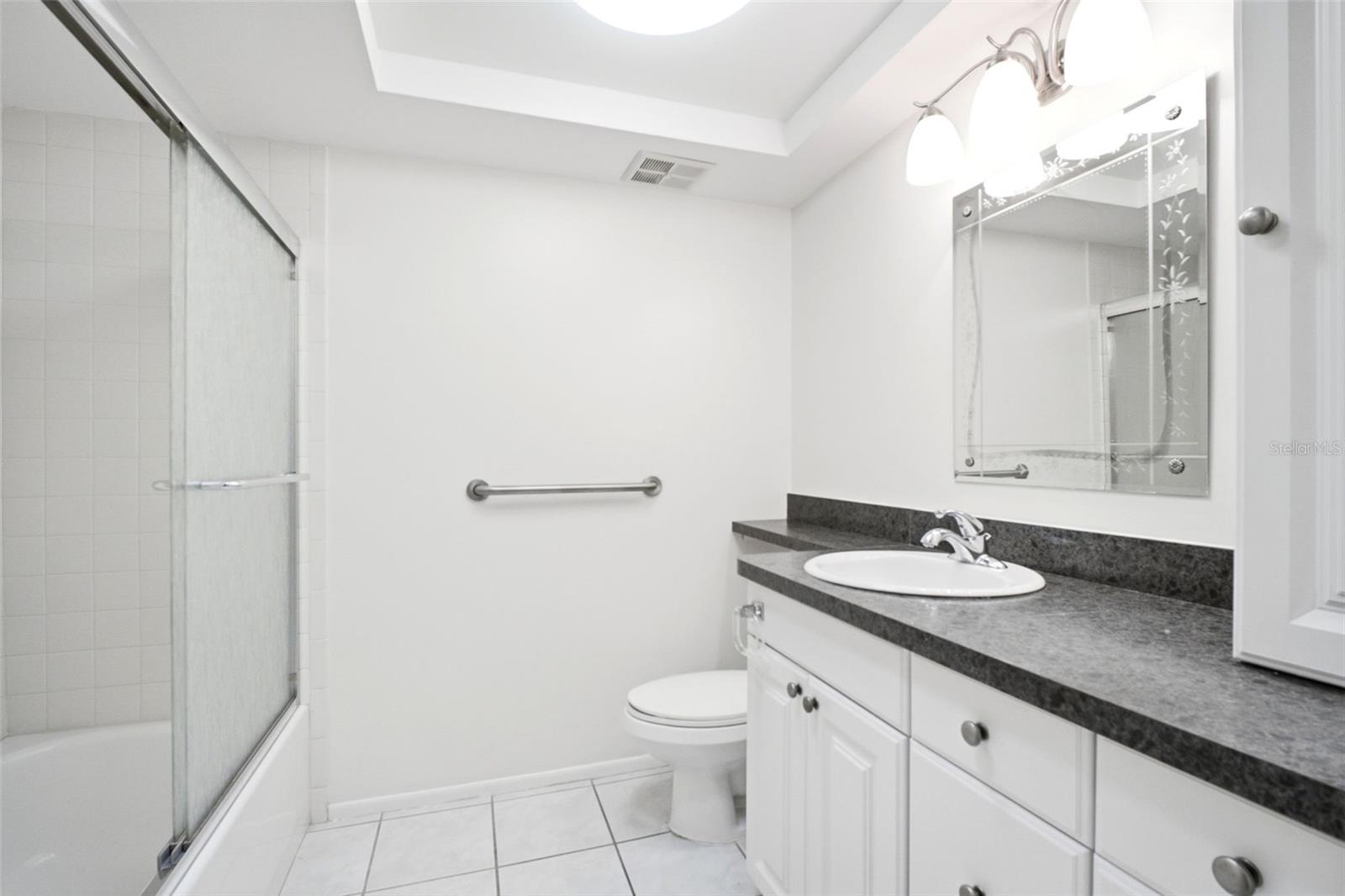 Updated hall bath conveniently located between the main living & guest suite~