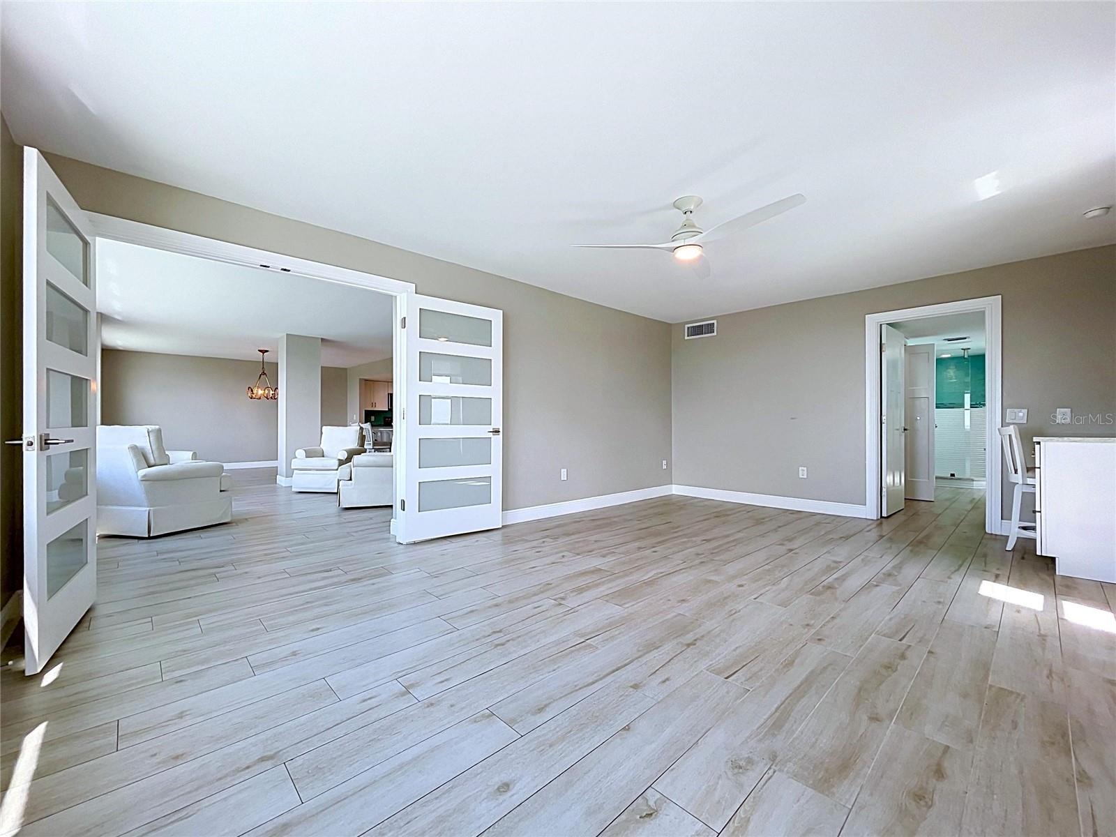 Oversized primary bedroom offers waterfront scenery and views of the Skyway Bridge in the distance.