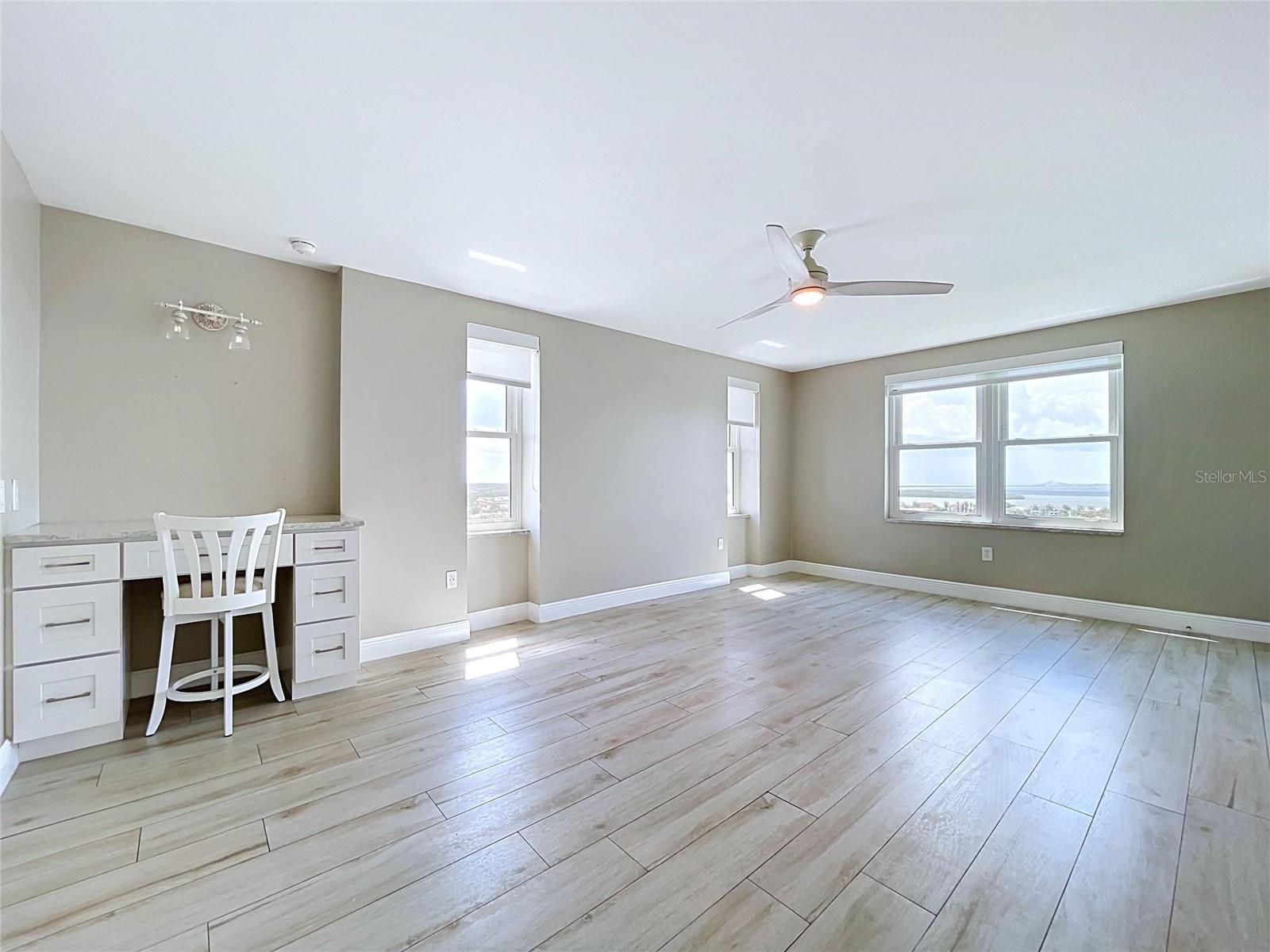 Oversized primary bedroom offers waterfront scenery and views of the Skyway Bridge in the distance.