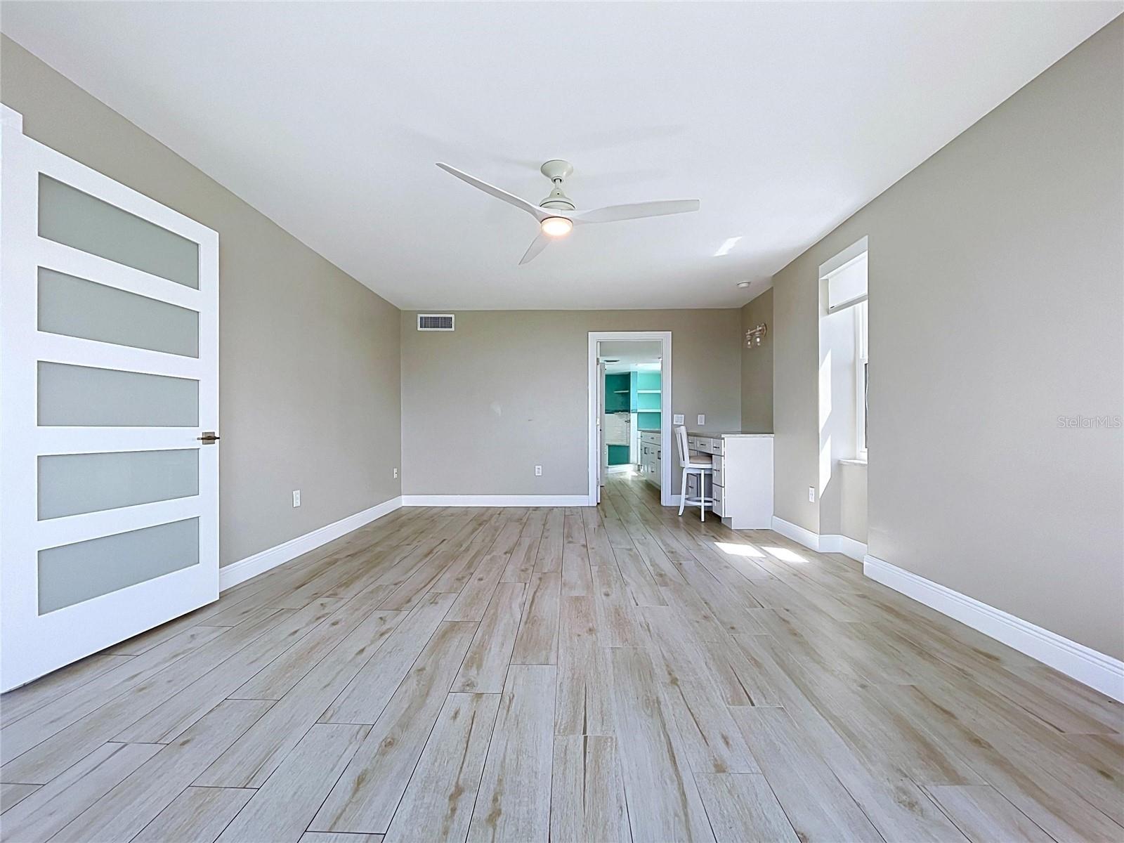 Oversized primary bedroom offers waterfront scenery and views of the Skyway Bridge in the distance.