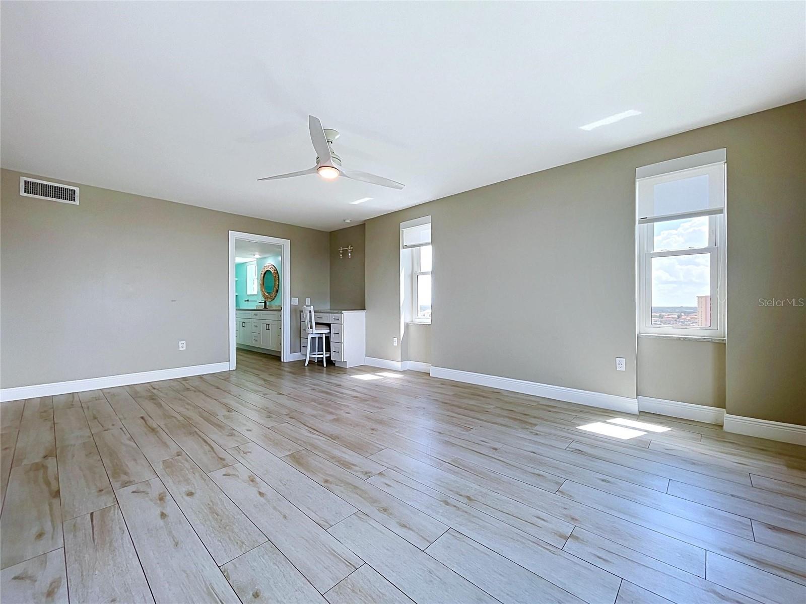 Oversized primary bedroom offers waterfront scenery and views of the Skyway Bridge in the distance.