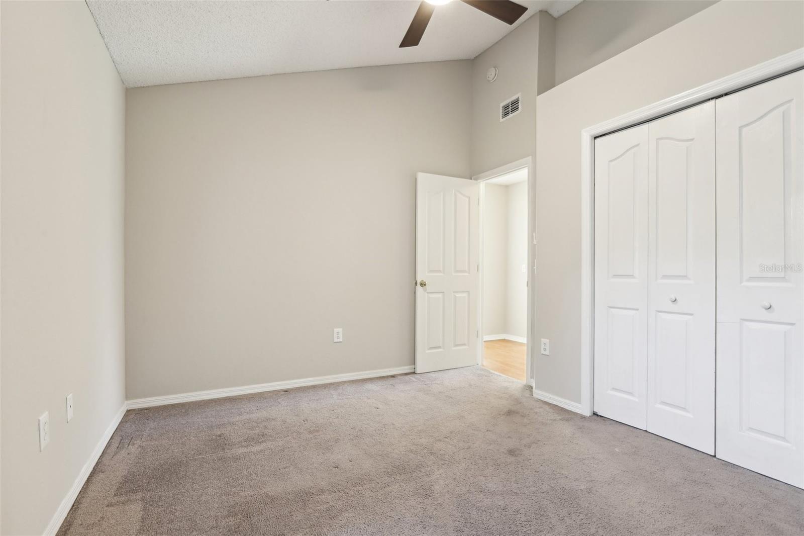 Bedroom 2 has vaulted ceilings and  reach-in closet with bi-fold doors.