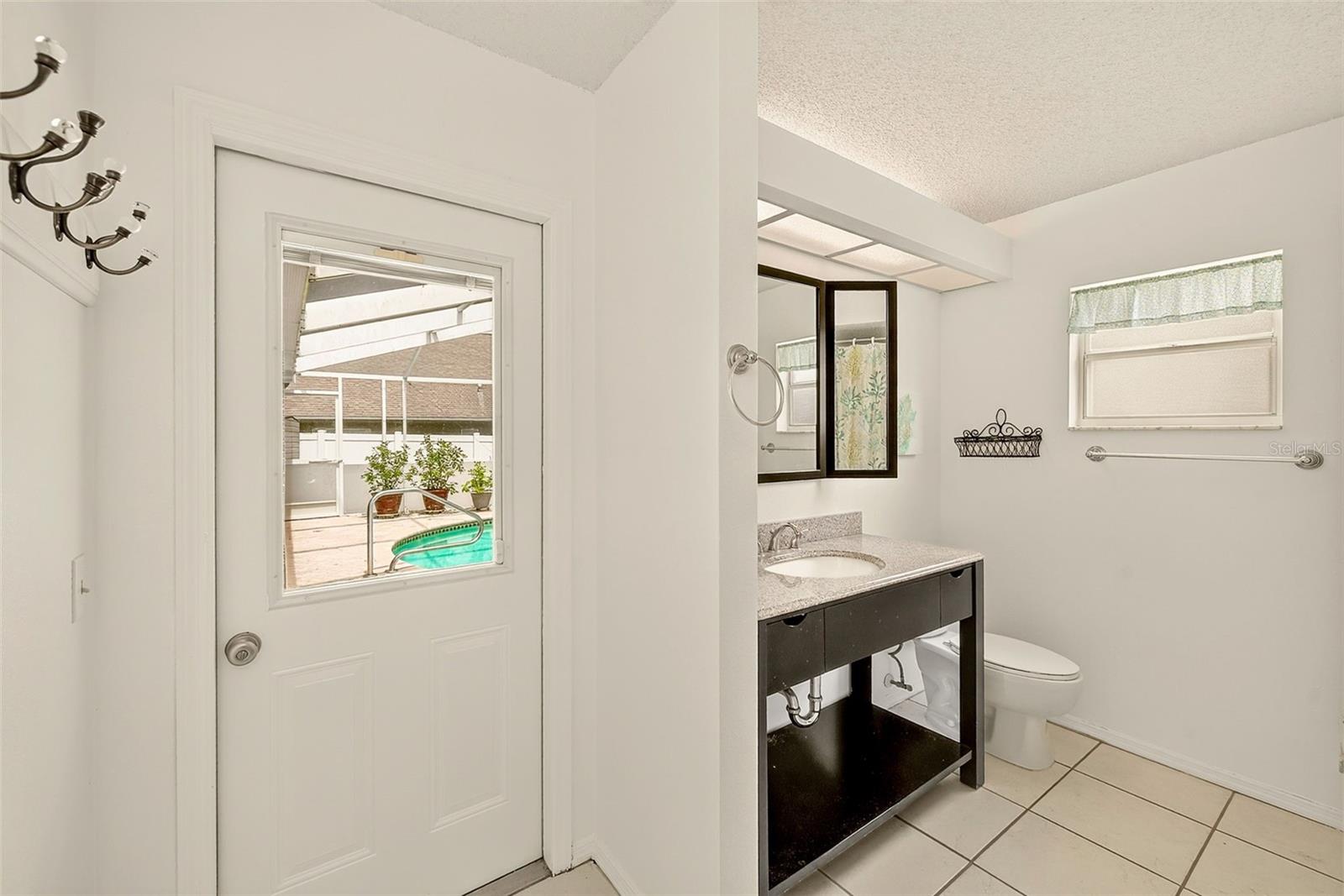 View of hall bathroom which could be a pool bathroom