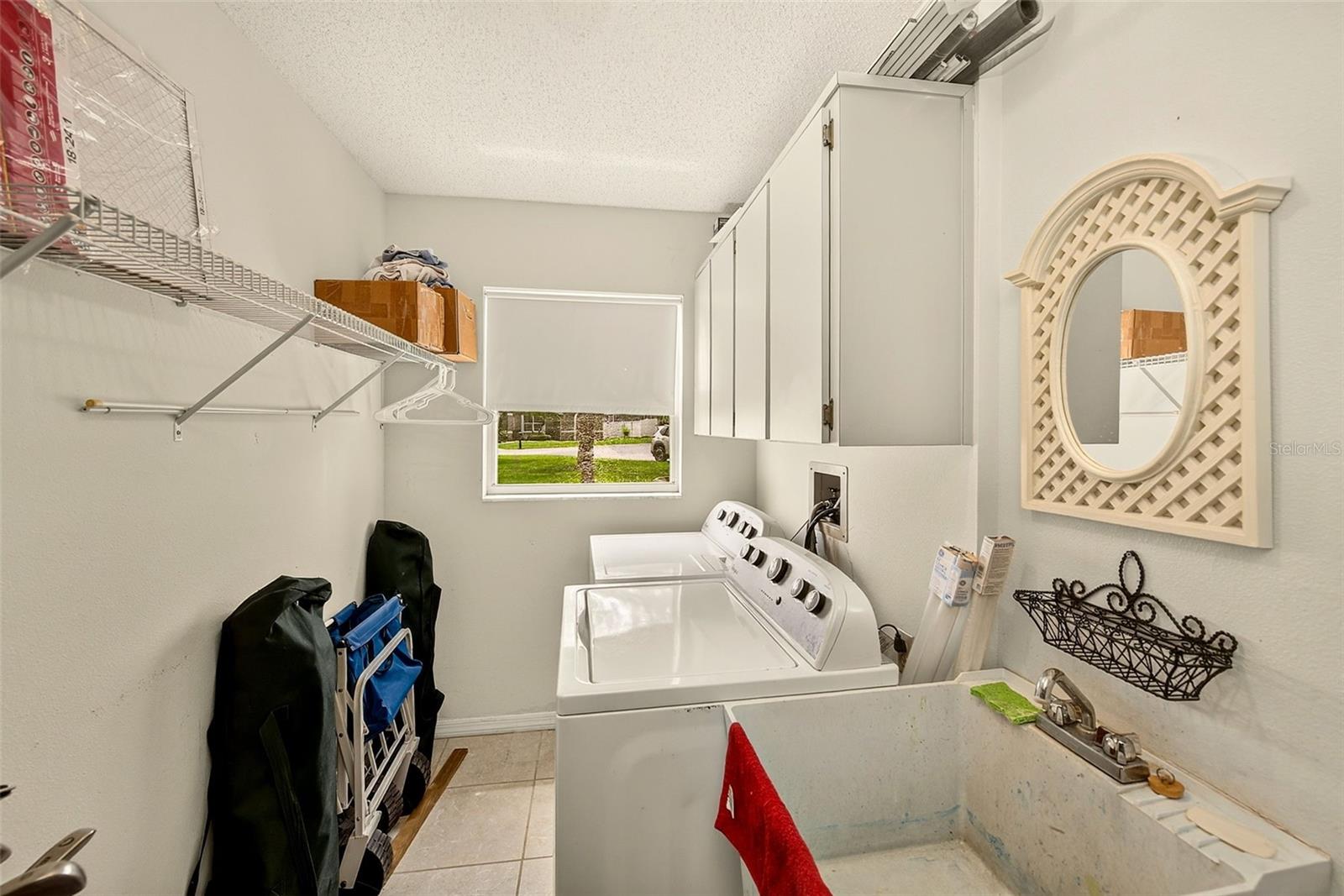 Air conditioned laundry room in garage with separate door