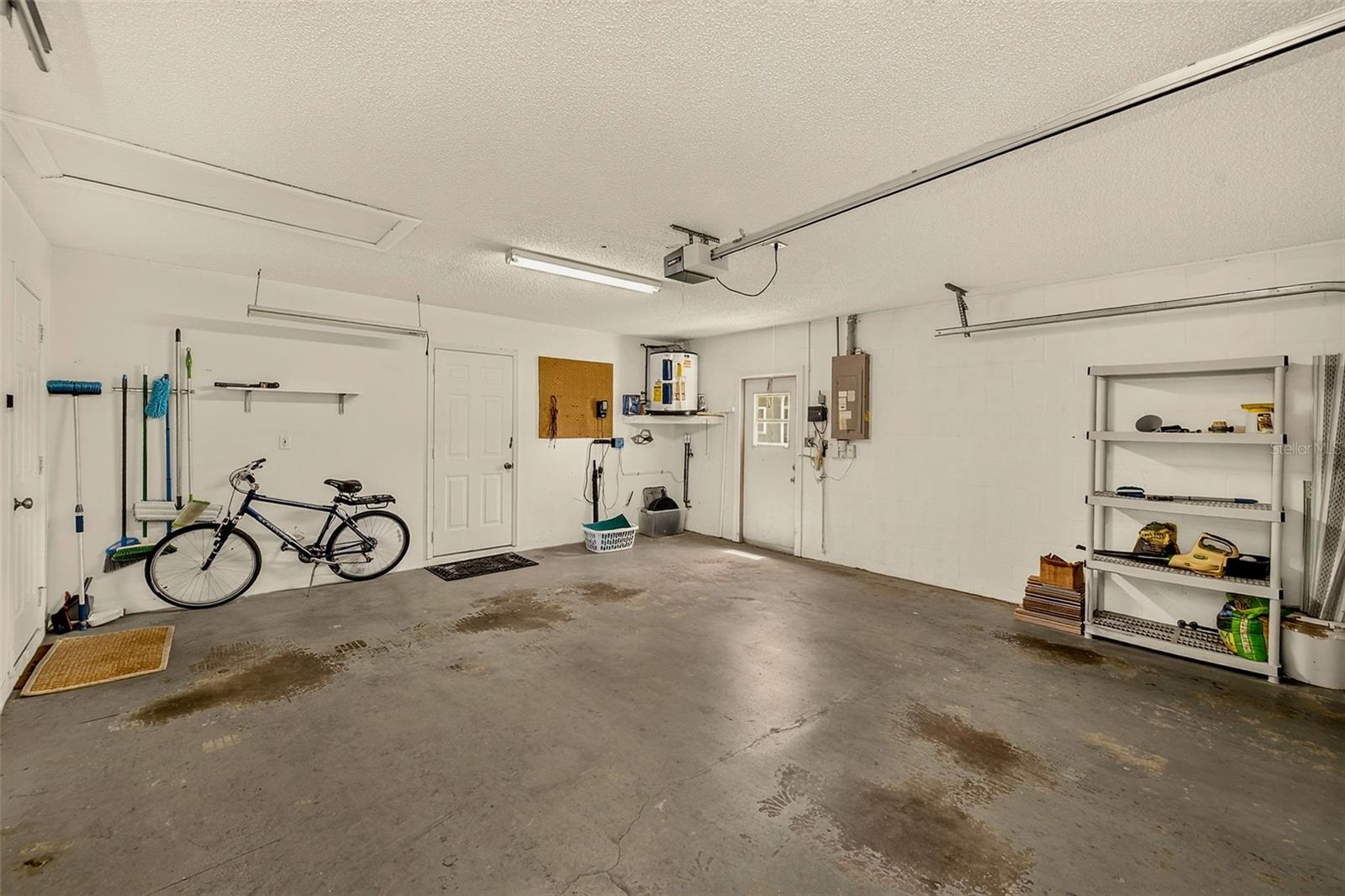 Garage with air conditioned laundry room (see paneled door)