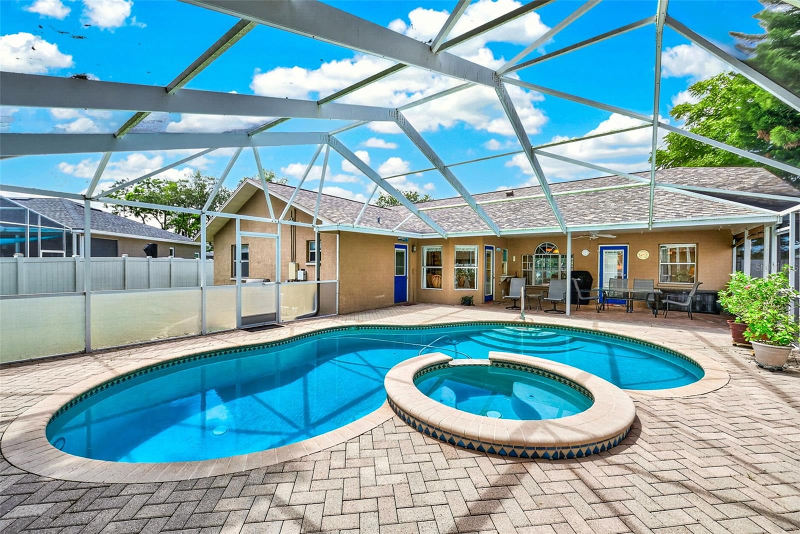 View of inground pool, spa and patio
