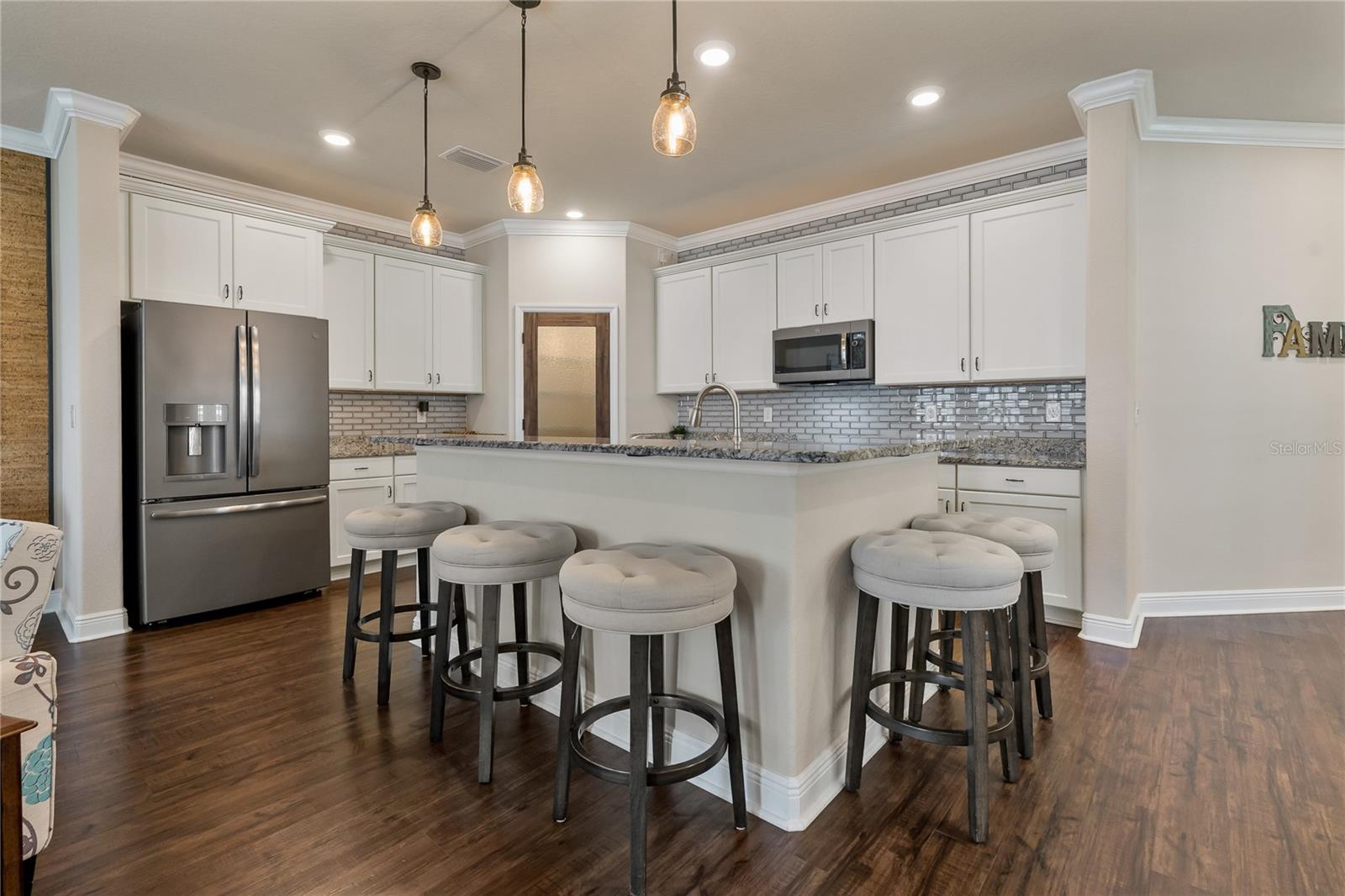 Beautifully Appointed Kitchen with Stunning Tile Backsplash & Extended Island