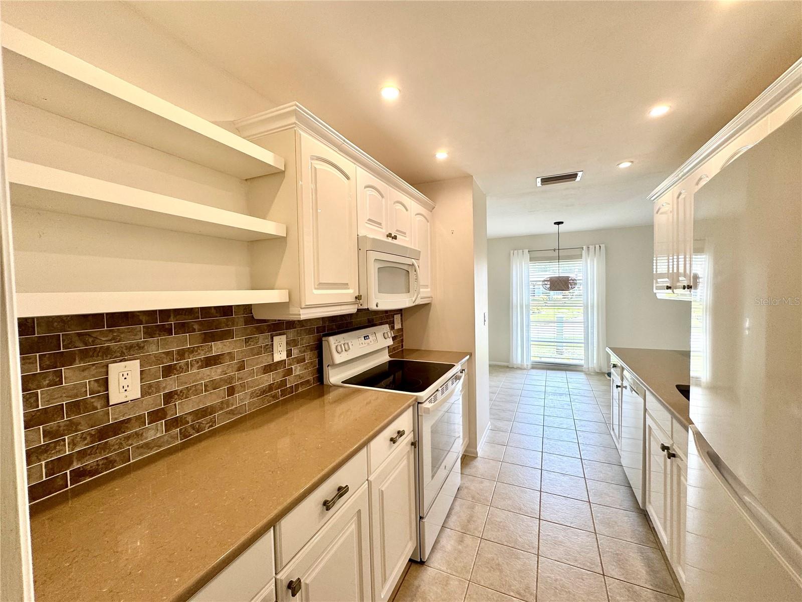 Updated Galley Kitchen leads to Dining Area