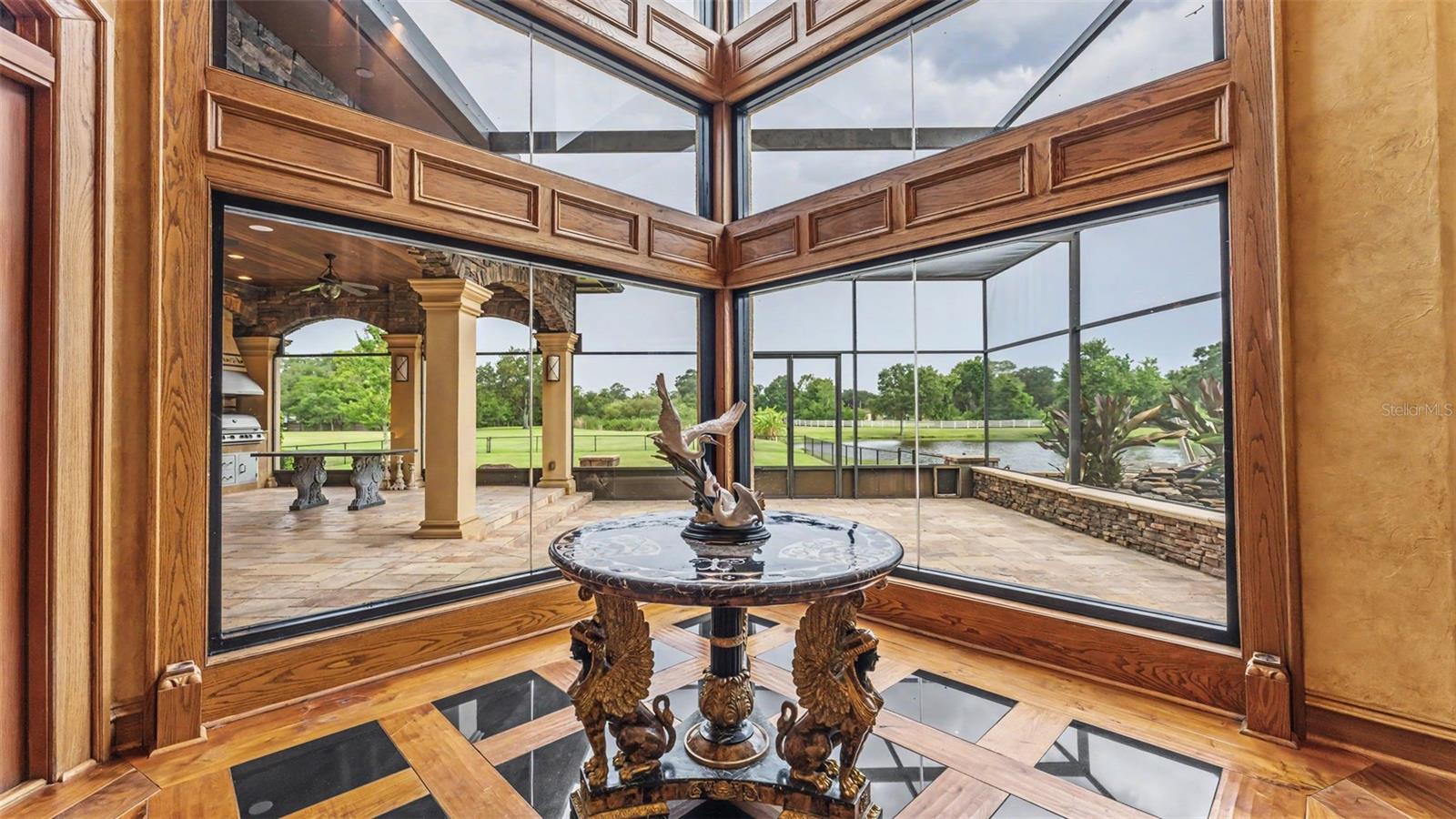 Framed with custom millwork this 30 foot Wall of Tinted Impact Glass -seamlessly blends the indoor luxury with the breathtaking views.