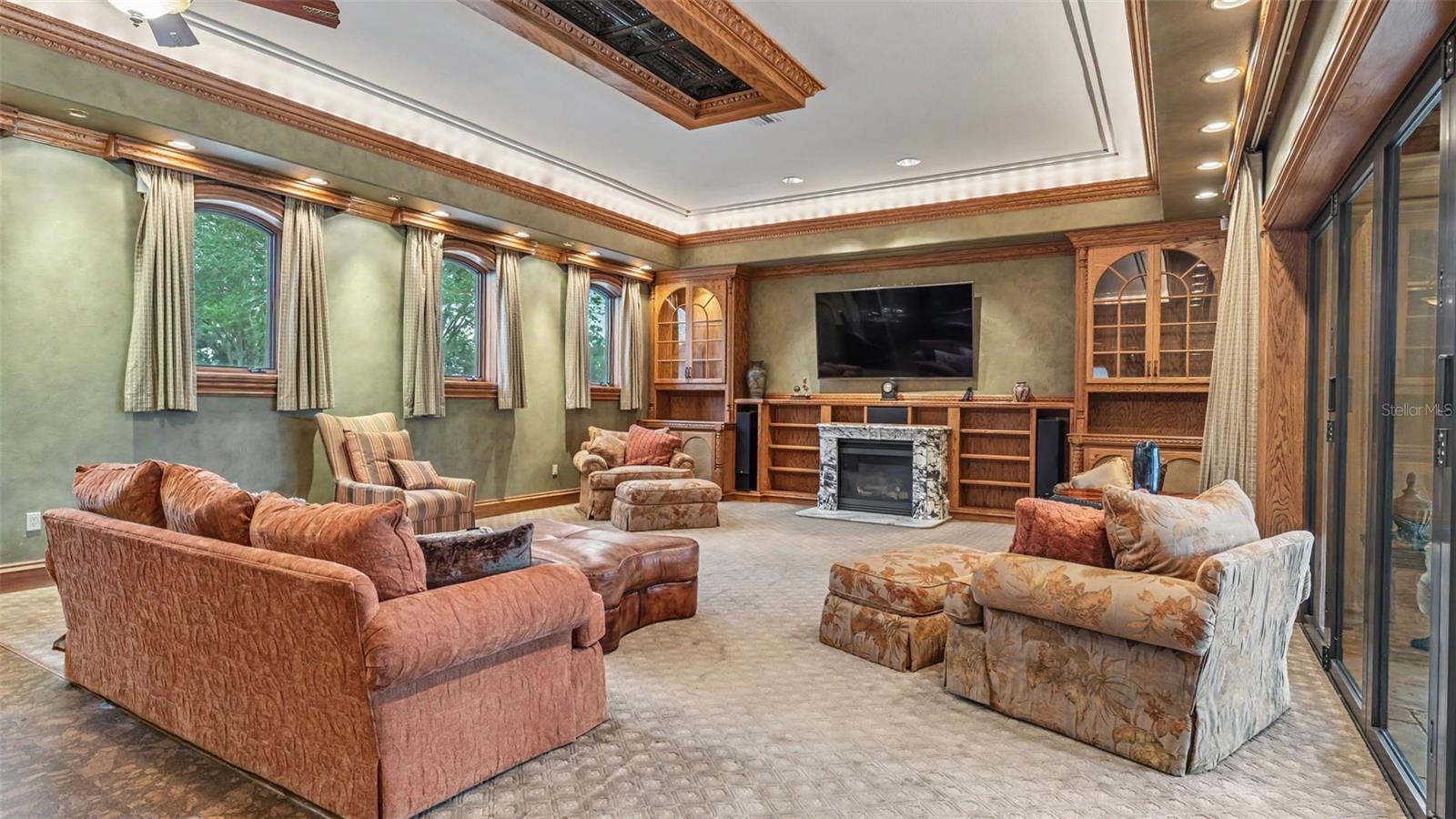 A Massive Family room offers ample seating for Family or Holiday Events. Elevated Windows allow light to flutter in and out of the French doors leading to the Lanai.