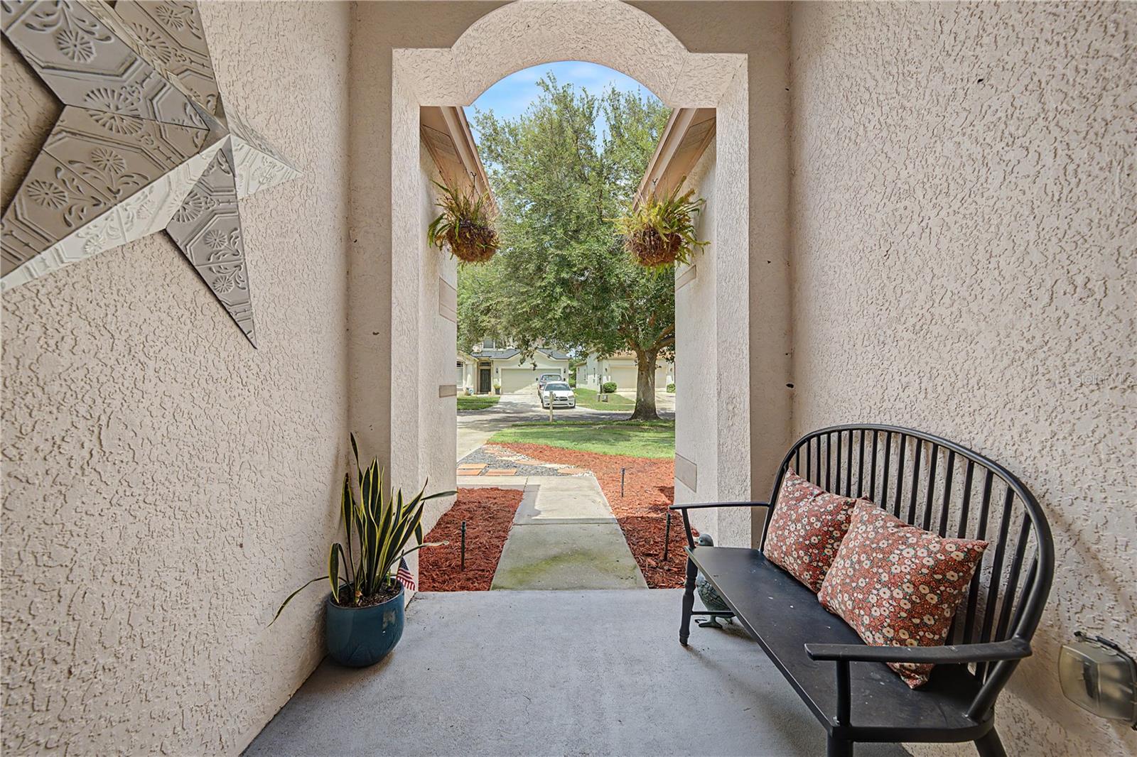 Arched entry to covered  front porch