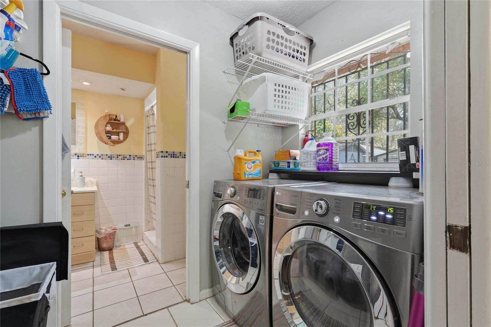 Laundry Room with two sets of Pocket Doors and a Window Looking into back yard