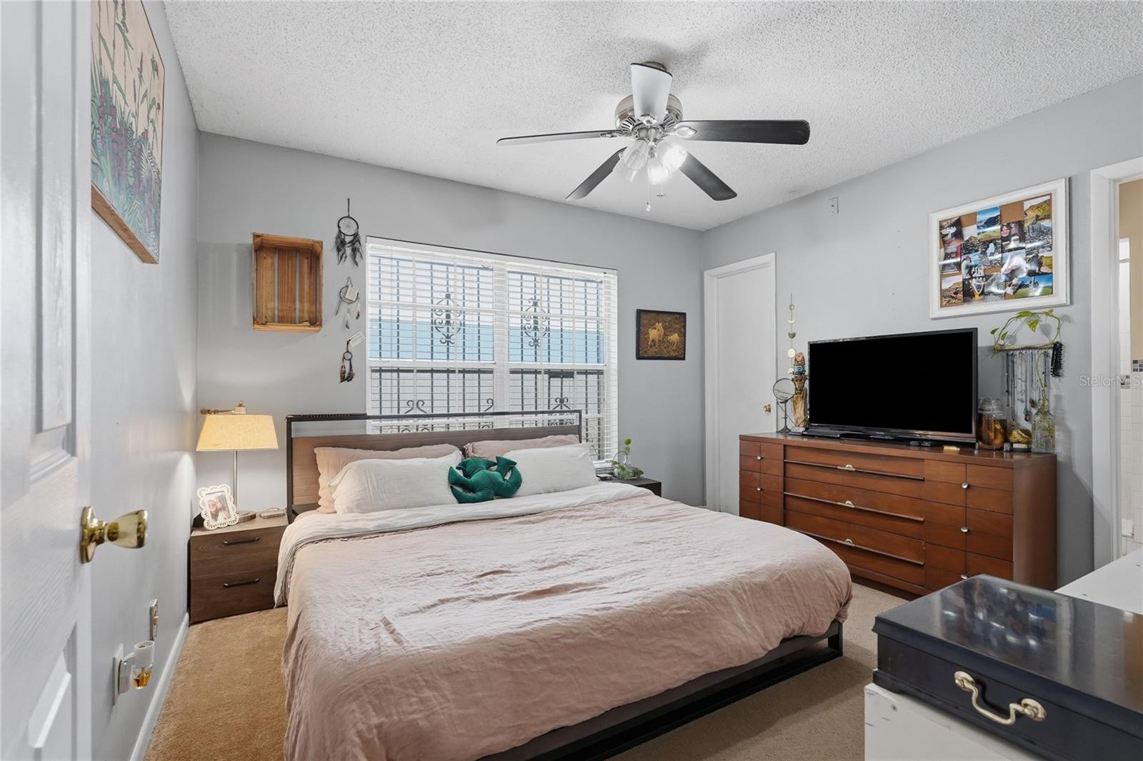 Primary Bedroom with Ceiling Fan and Walk In Closet