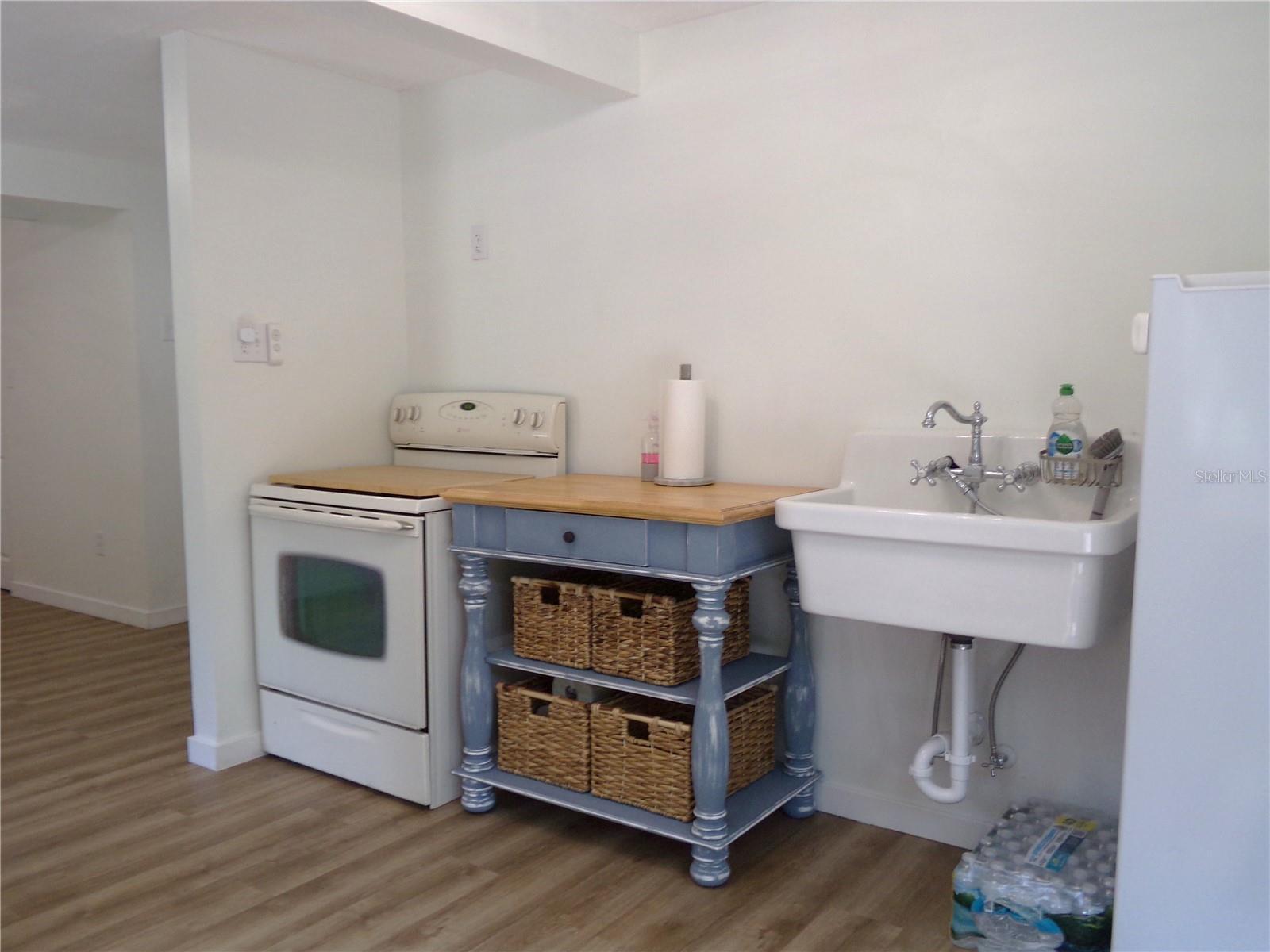 First Floor Kitchenet with stove, refridgerator, work station and sink.