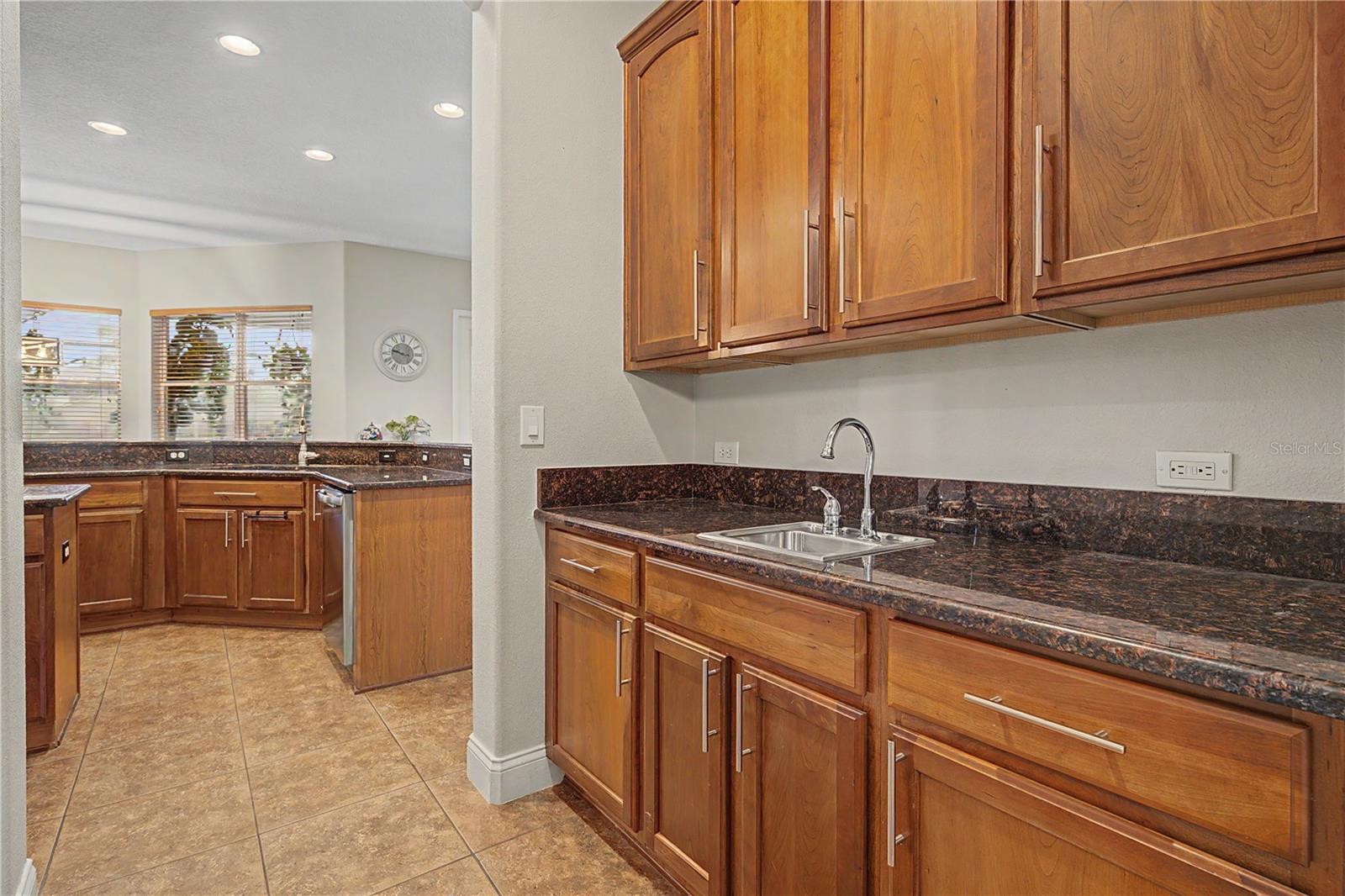 Butlers pantry between dining room and kitchen with walk in pantry
