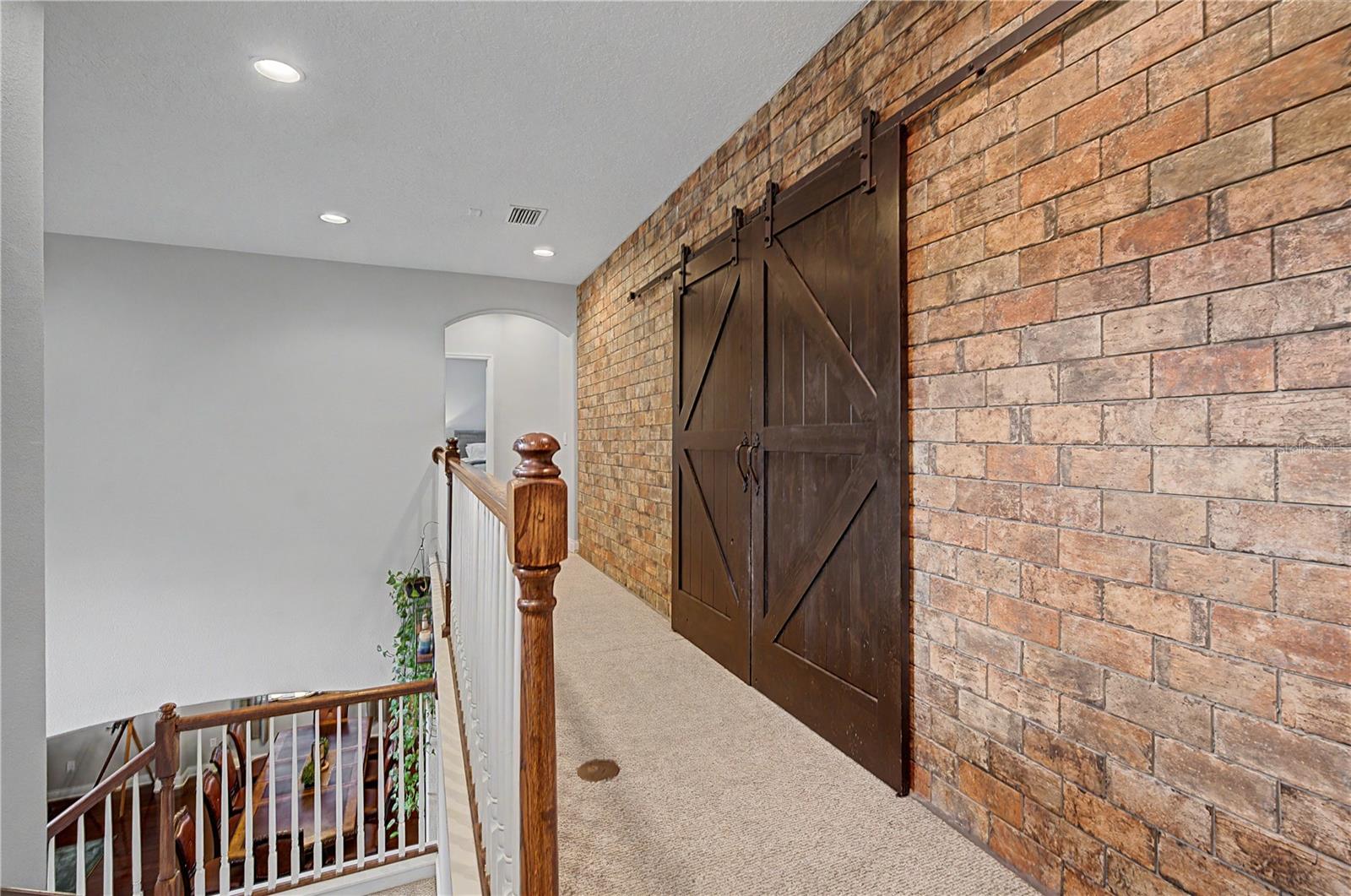 Brick accent wall upstairs to Bonus room