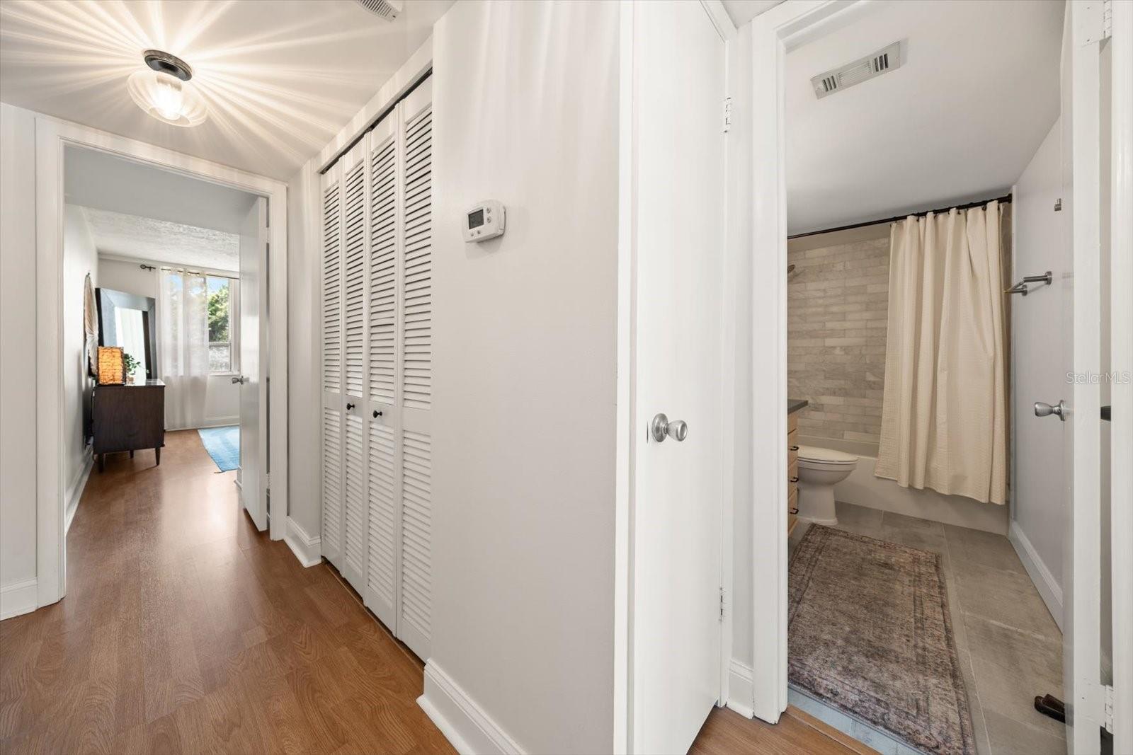 Hallway with linen closet outside of 2nd bath.
