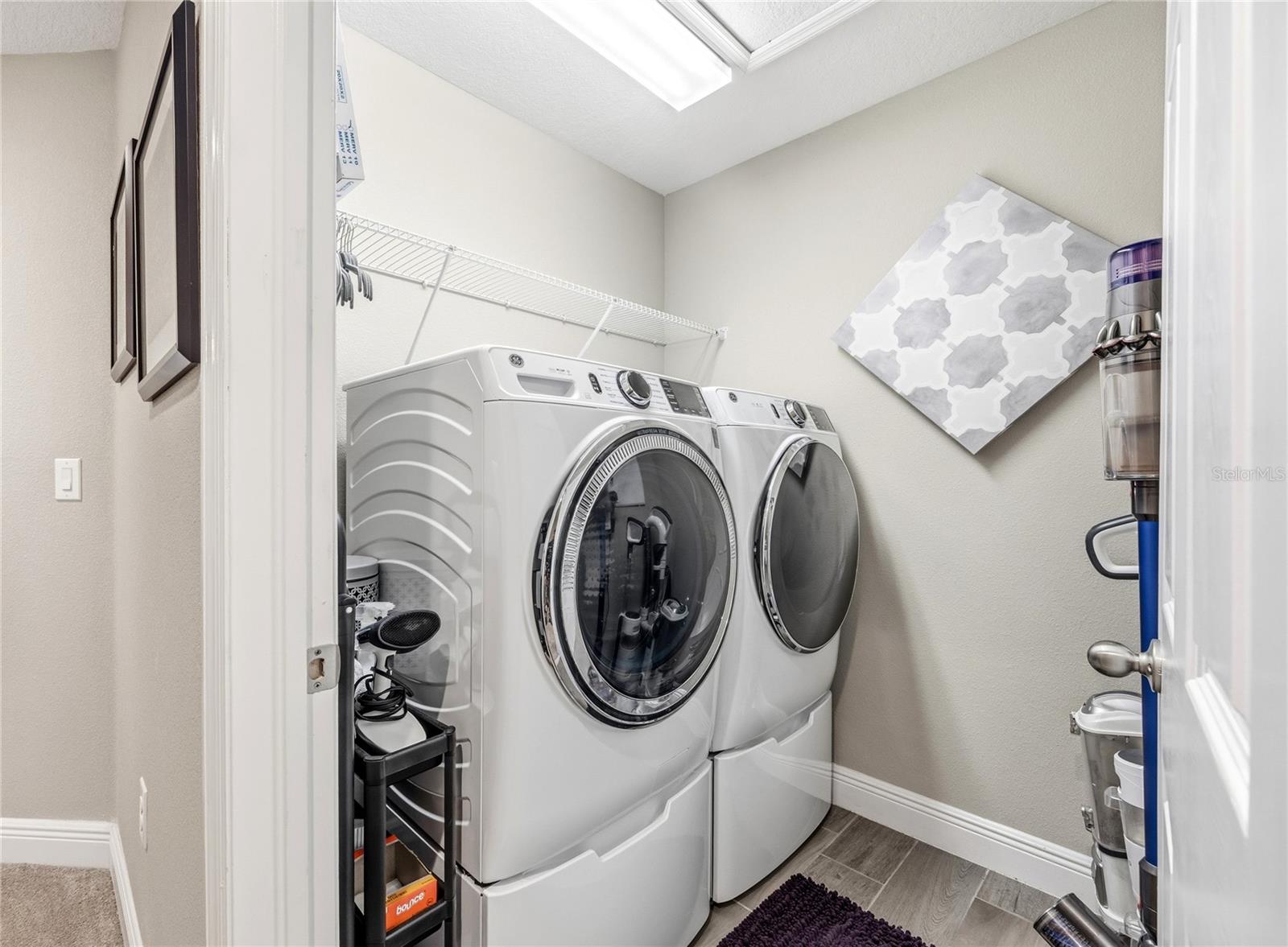 Laundry upstairs with storage space