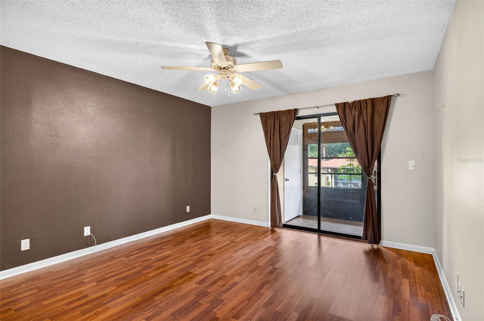 Primary bedroom with sliding doors to the balcony.