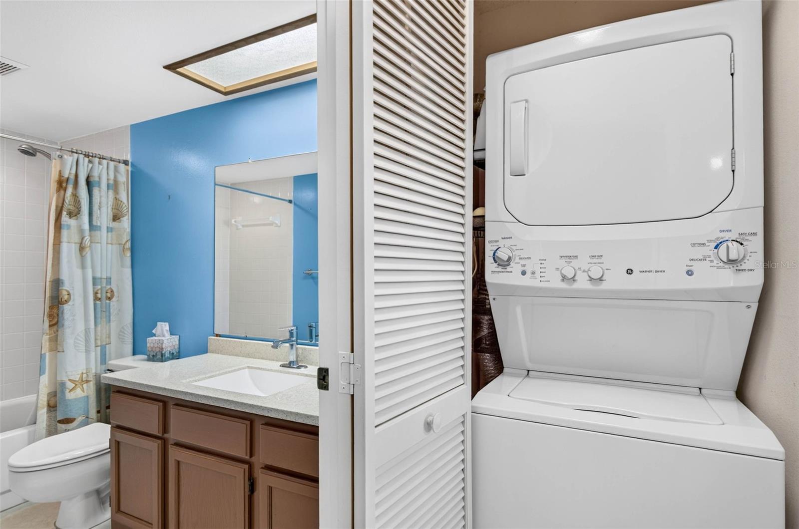 stackable washer dryer in the hallway.