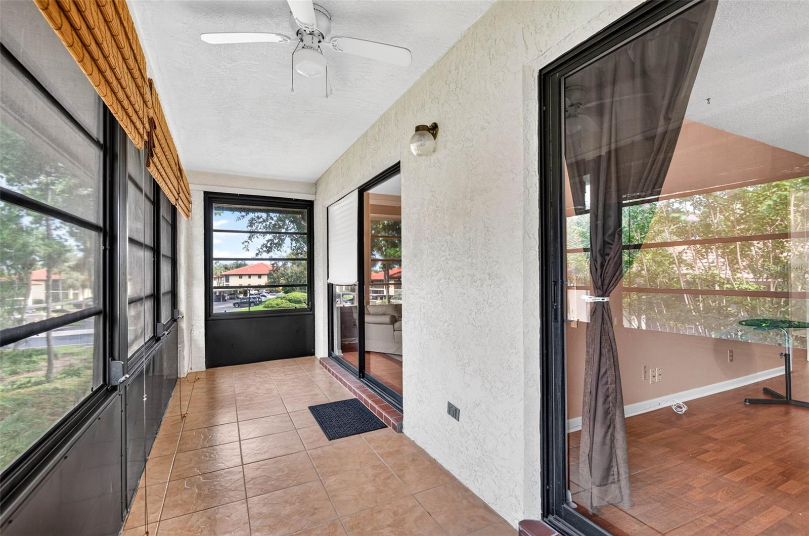 Balcony with sliding doors from both living room and primary bedroom.