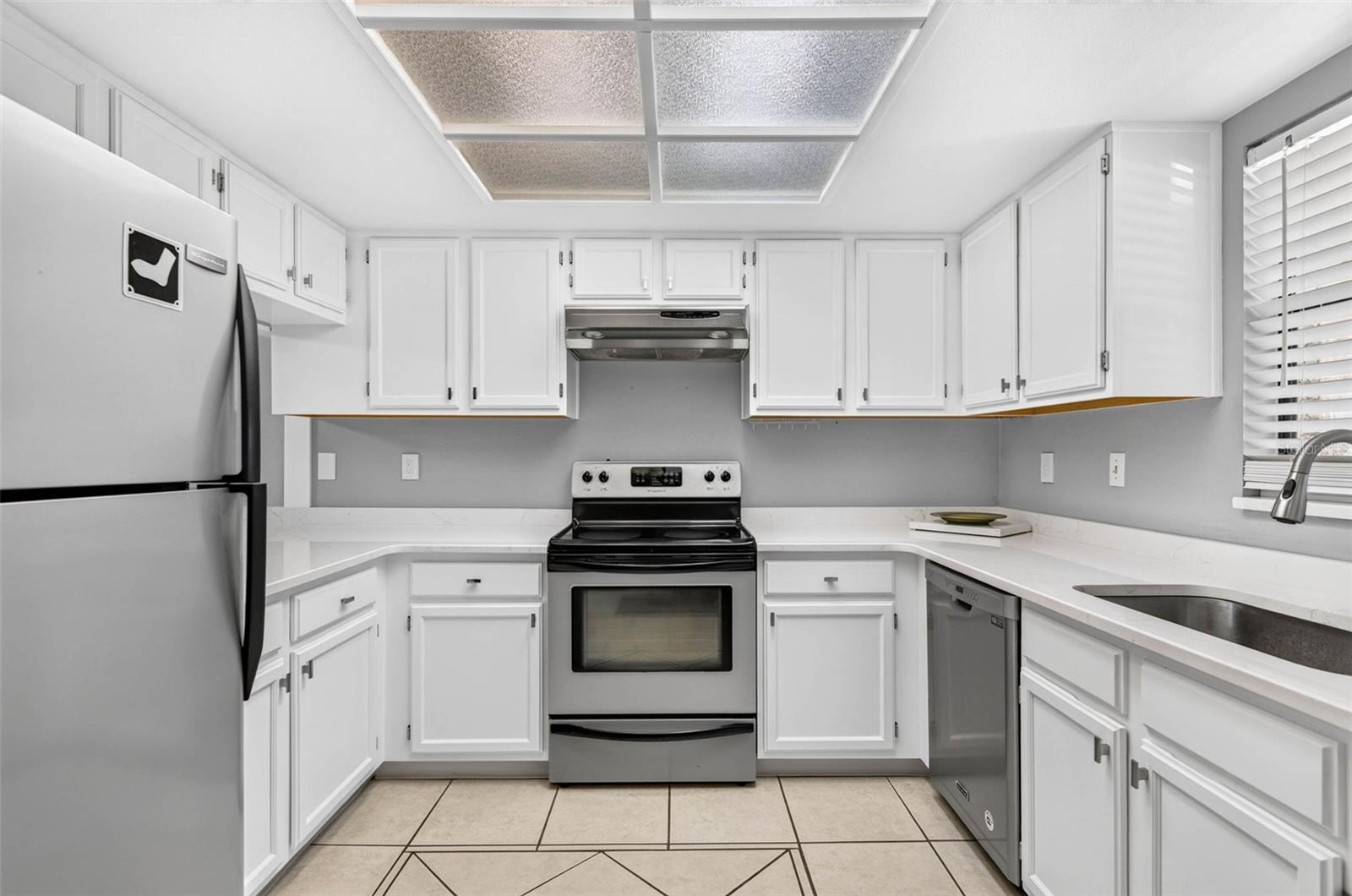 Kitchen with Quartz countertops and stainless steel appliances.