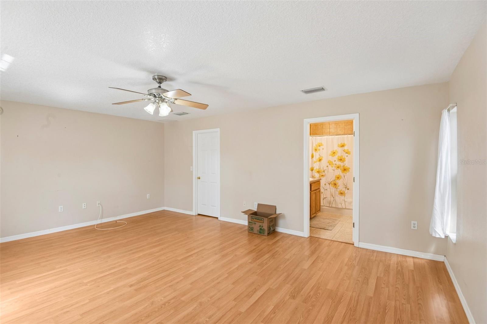Primary bedroom showing entry to bath and door to walk in closet