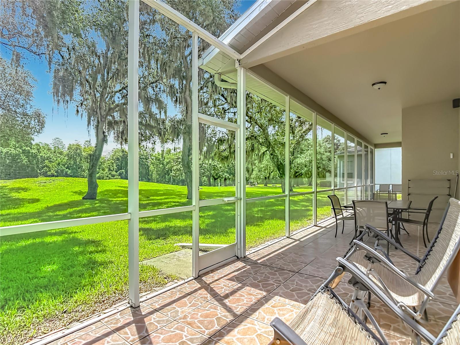 Screened Lania extends the entire width of the rear of the home.