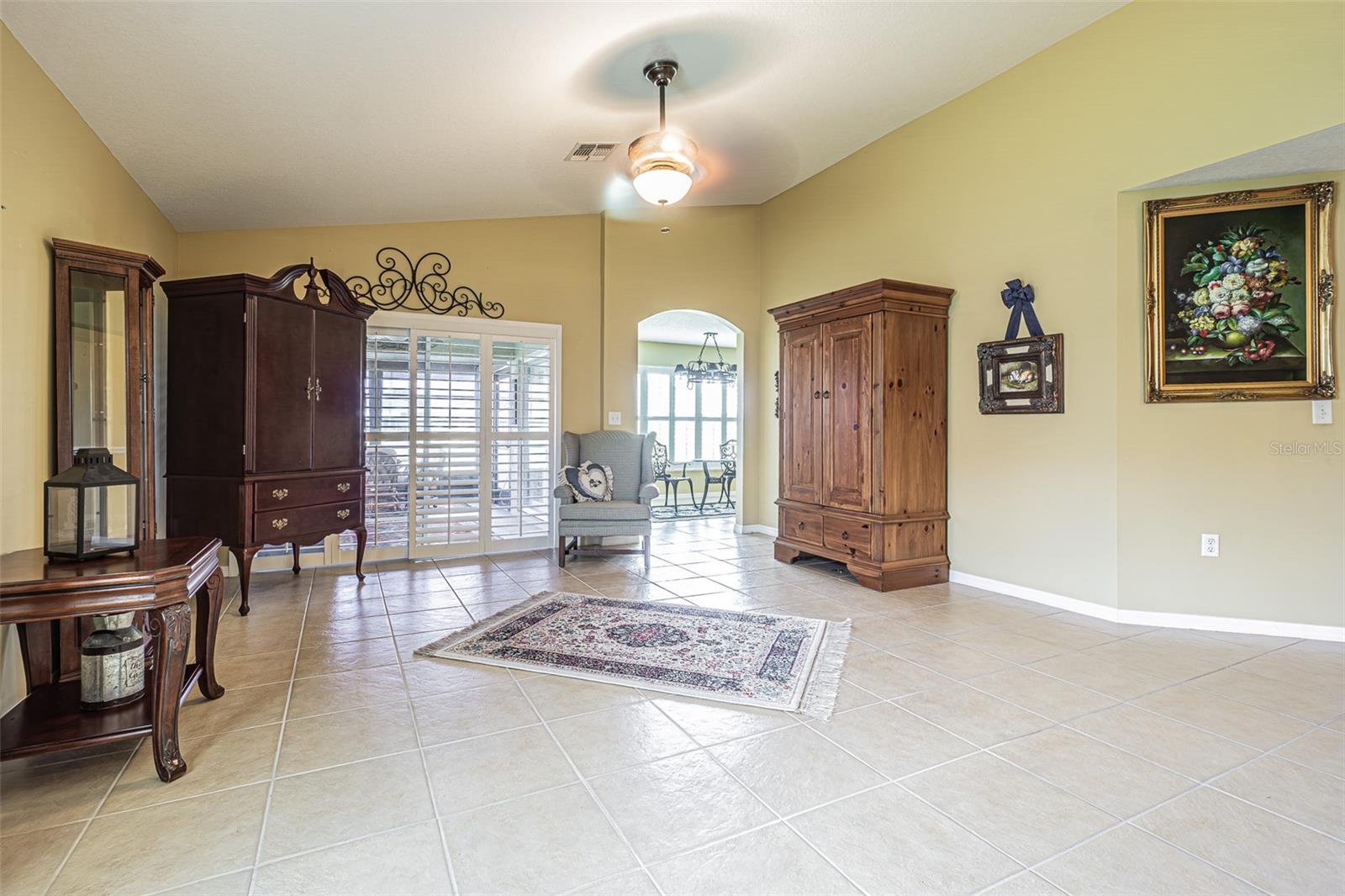 Plantation shutters and archway to kitchen area off Living room