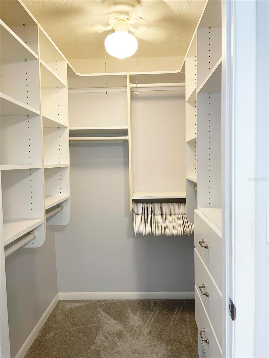 Custom built ins compliment the walk in closet