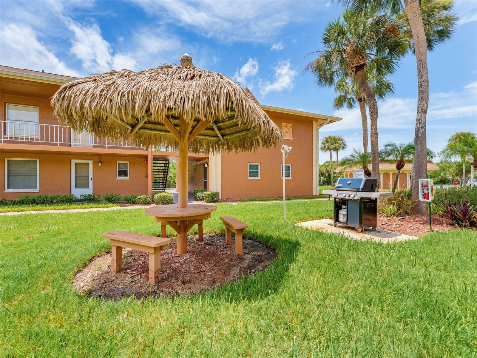 Community Tiki hut style picnic table grills throughout the complex