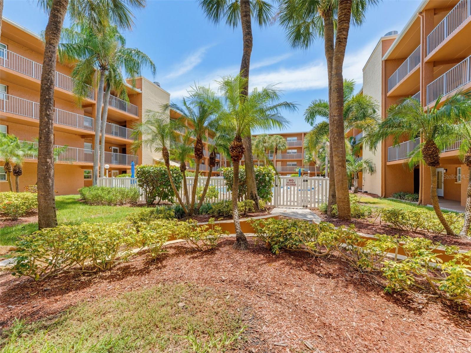 View of tropical landscape outside front door of unit #1004