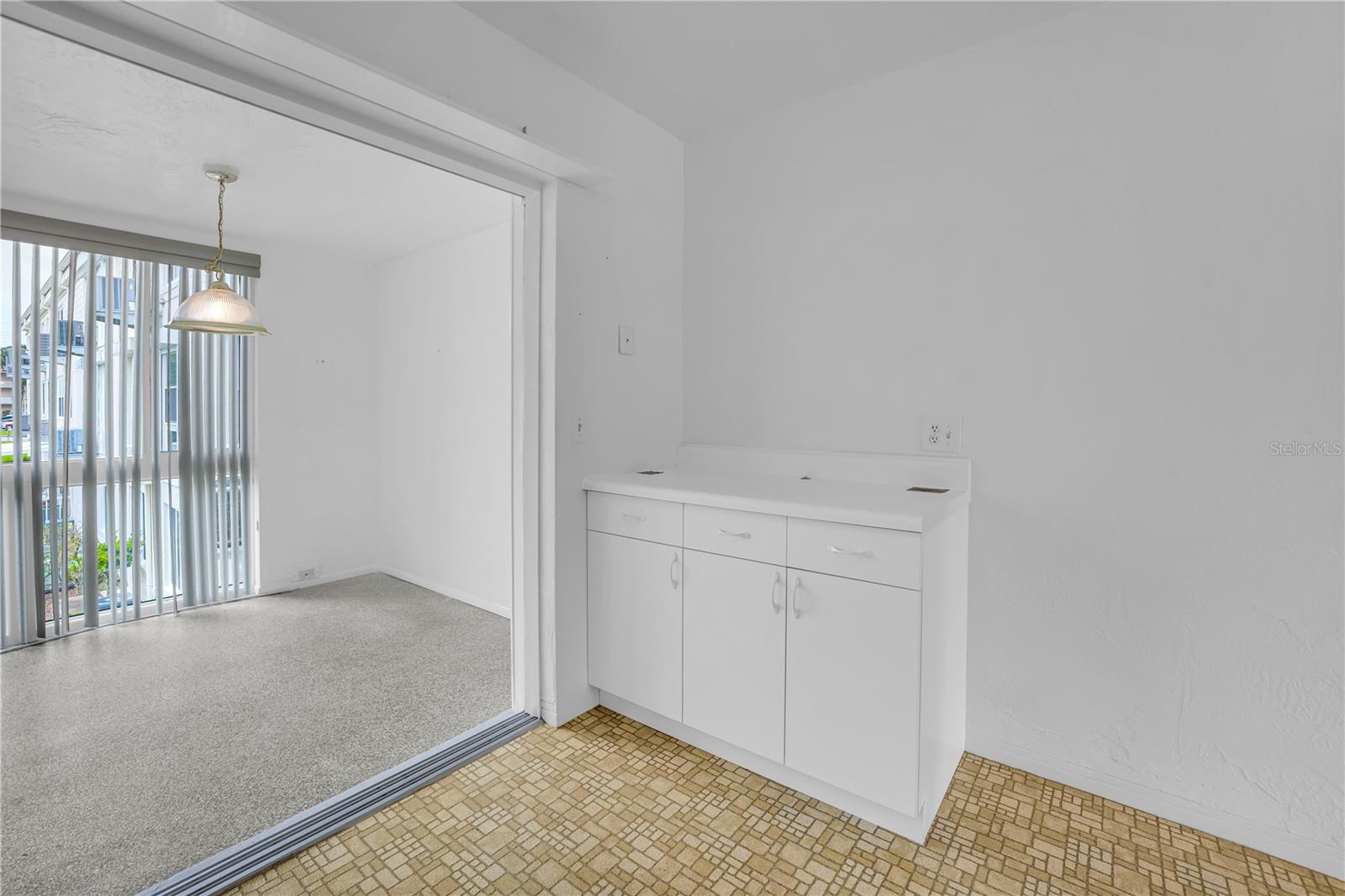 View from kitchen to sunroom (with extra counter/storage space)