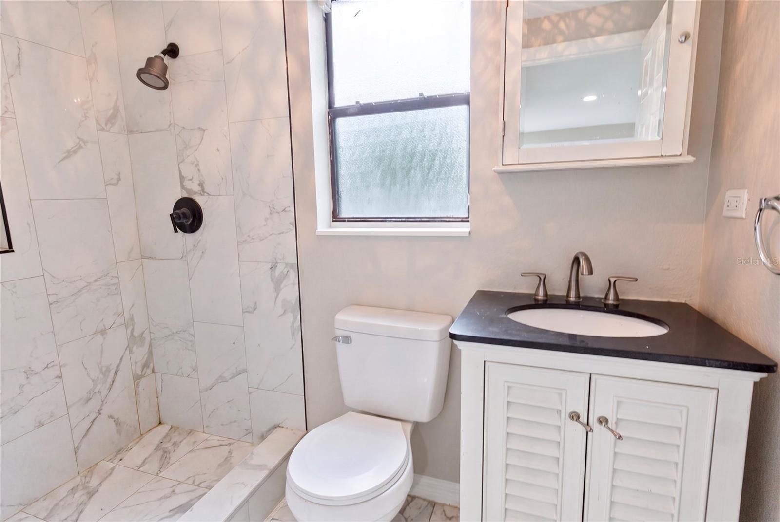 Upstairs updated bathroom with step in shower