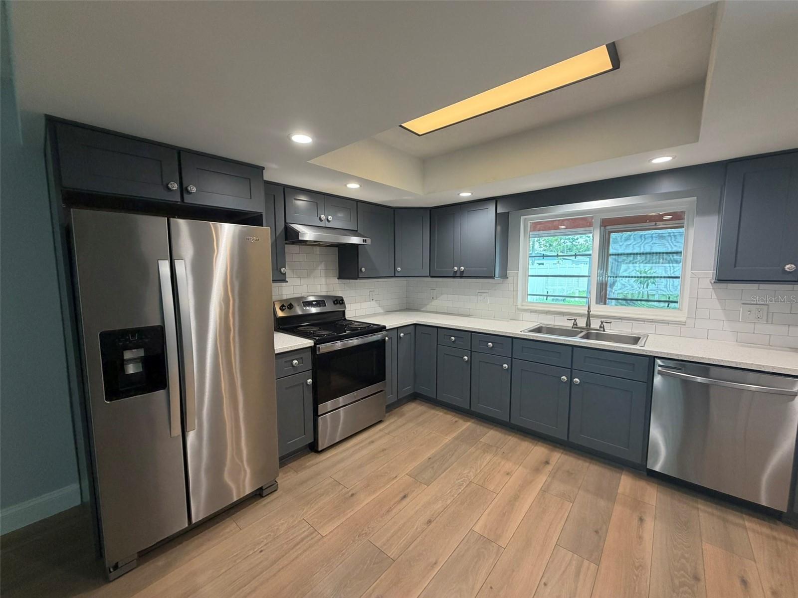 Enjoy cooking in this recently remodeled kitchen with quality JSI grey Shaker cabinentry & quartz countertops.