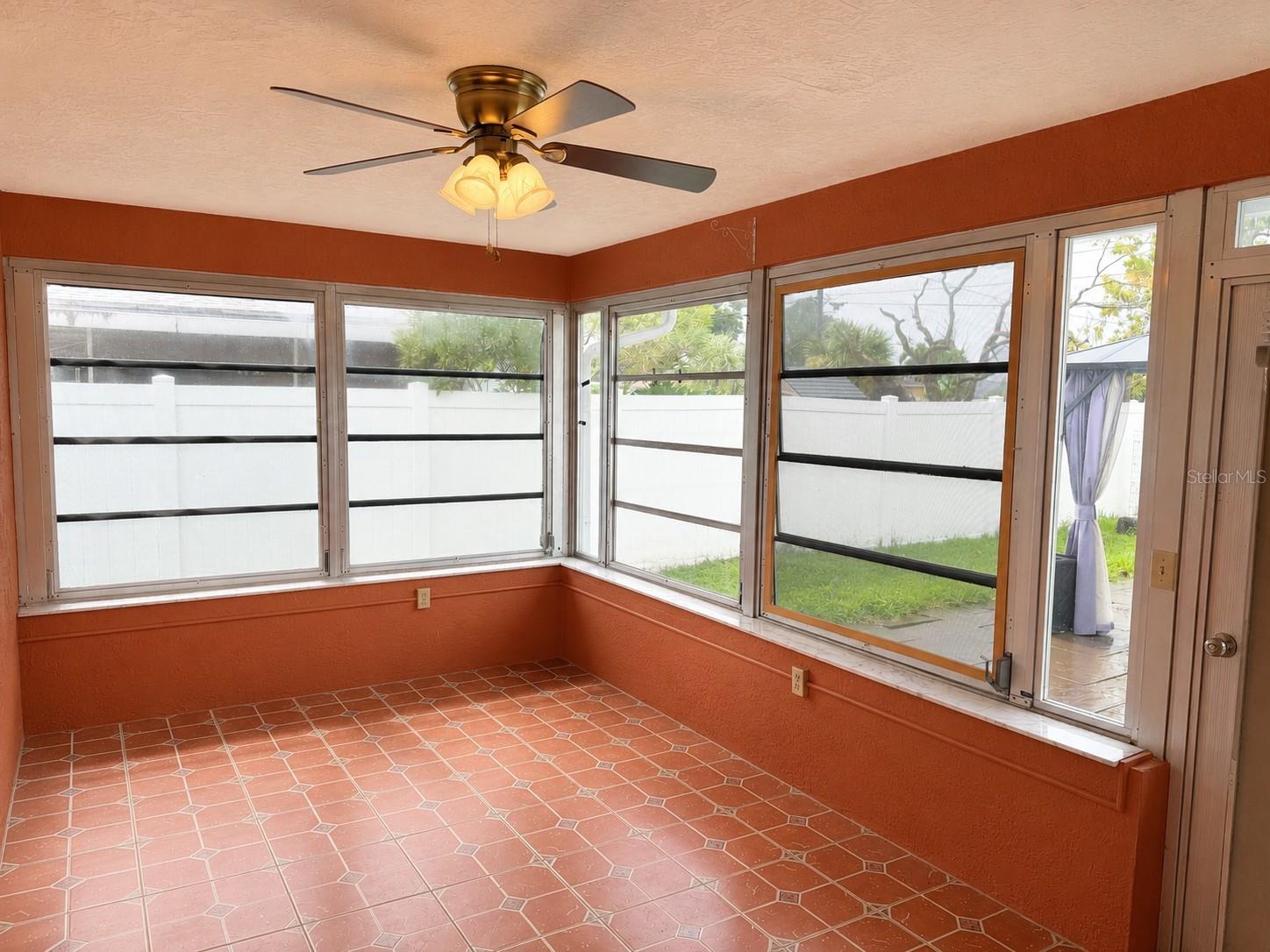 The Florida room brings in natural light and adds charm and space to the home.