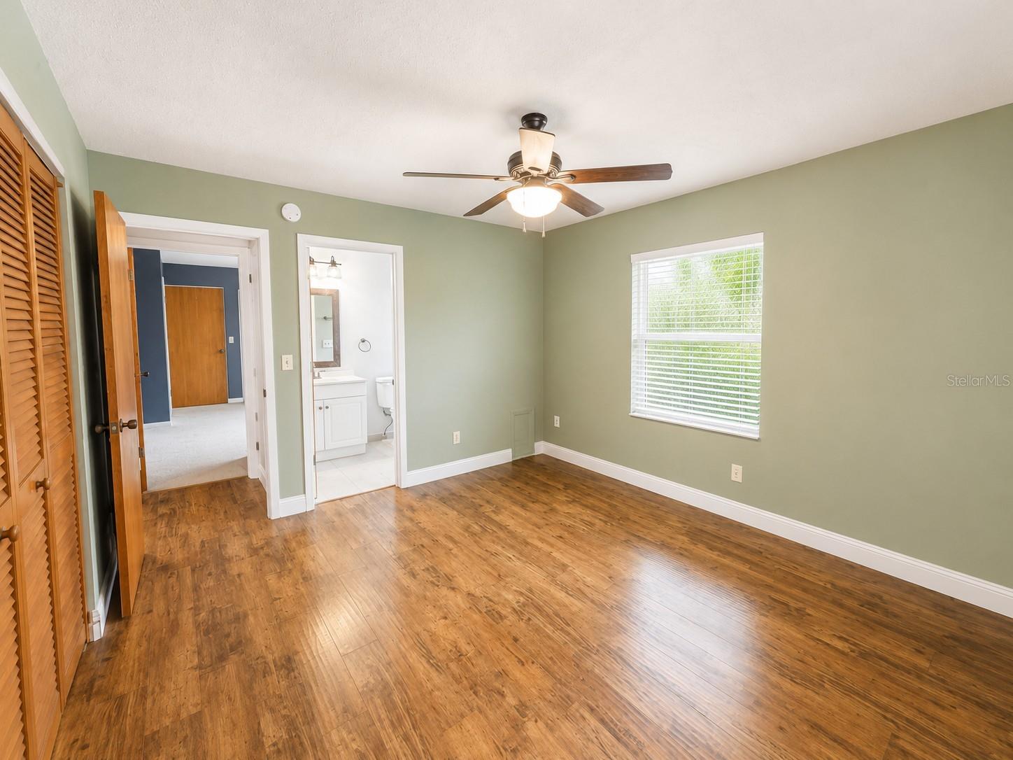 The primary bedroom features an ensuite full bathroom with lovely flooring!