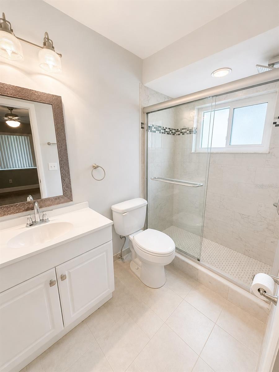Primnary Bathroom features a lovely base cabinet and framed mirror.