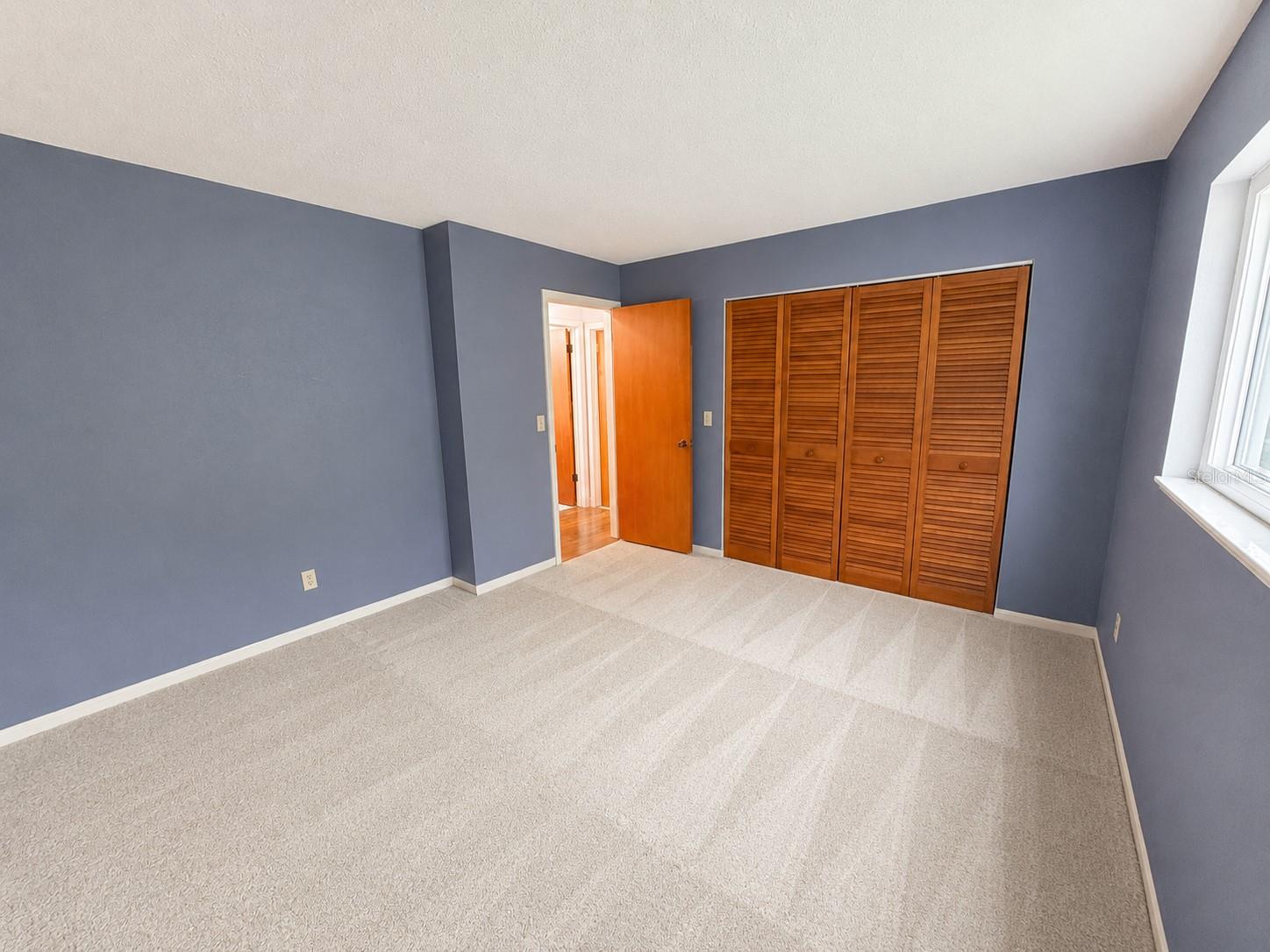 The second bedroom is spacious with natural lighting and steps away from the second full bathroom.