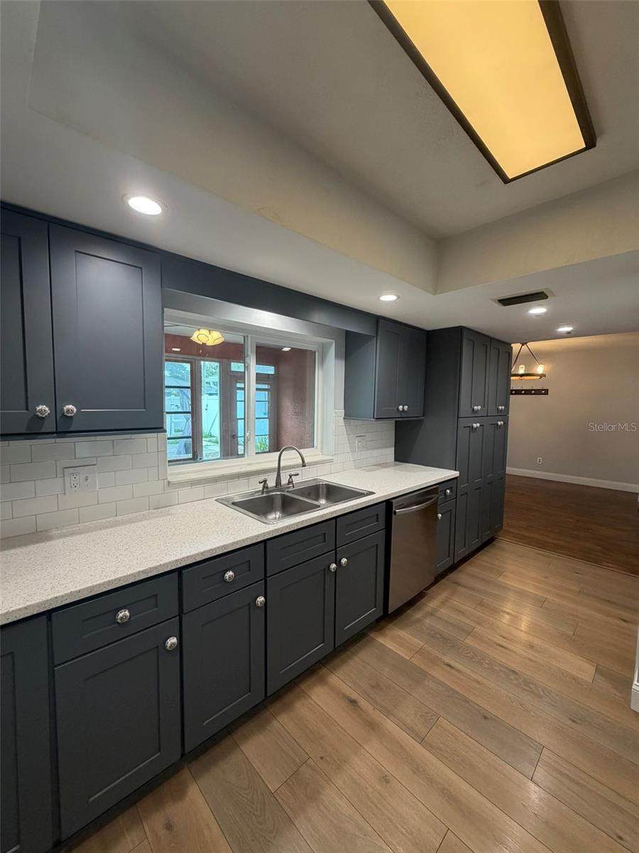 The kitchen offers plenty of counter space, soft-close cabinetry & abundant storage with pull out drawers!