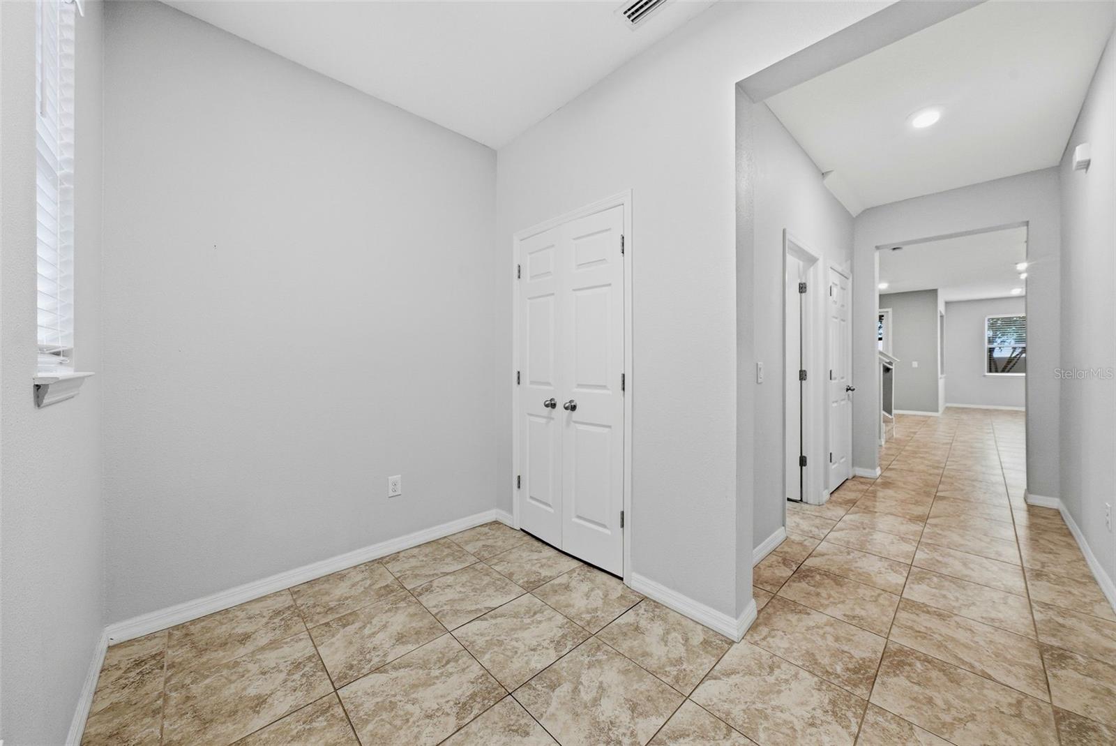 The entrance provides space for shoe and coat storage, as well as room for a bench or a mud room set up.
