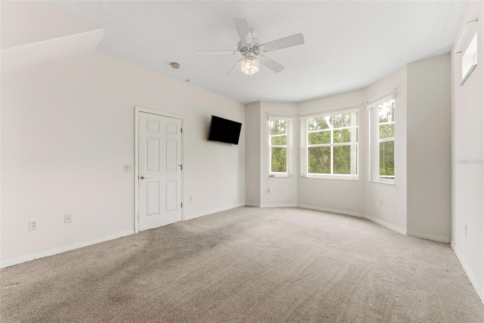 The bay window offers natural lighting in your primary bedroom.
