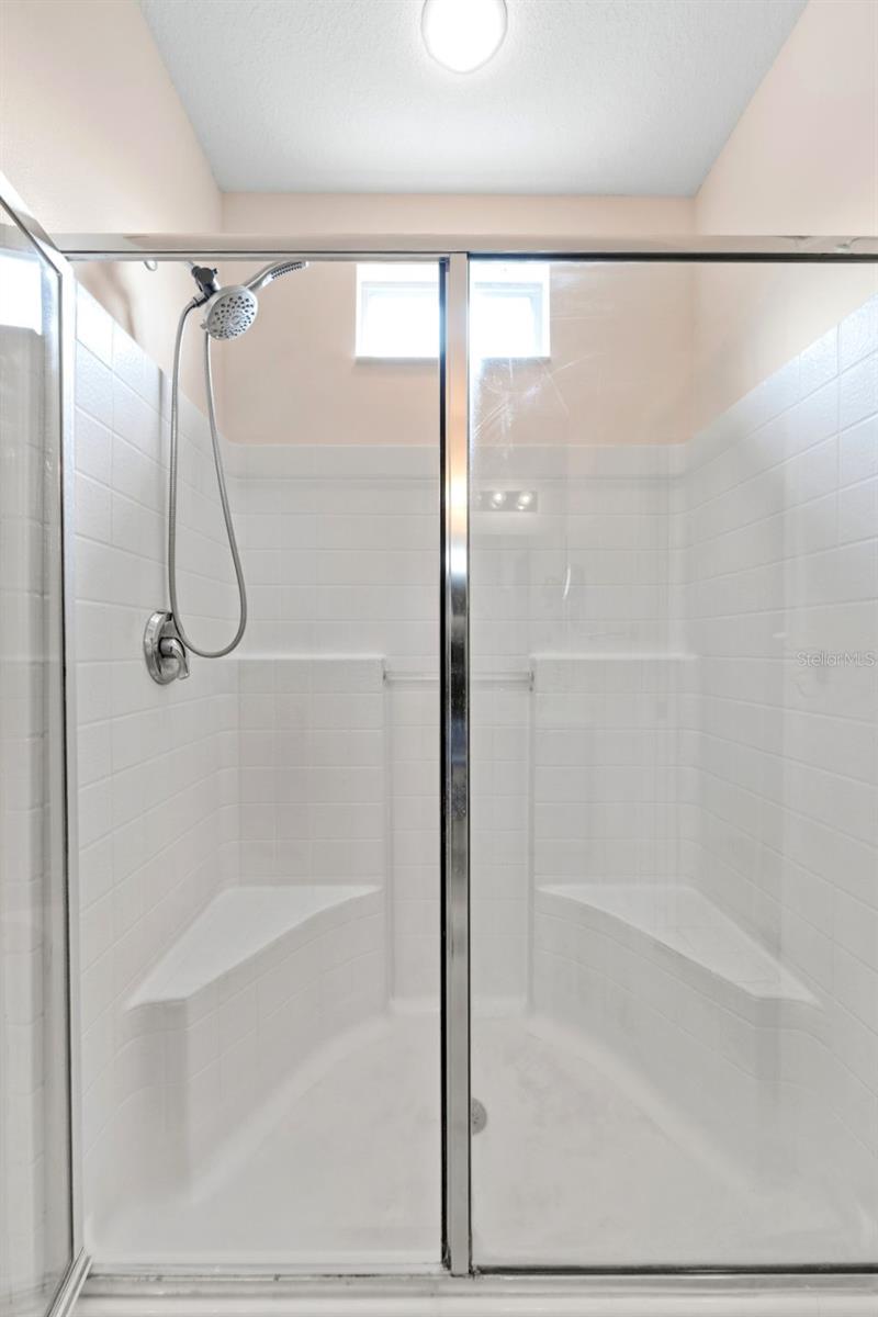 The primary shower has two bench seats.