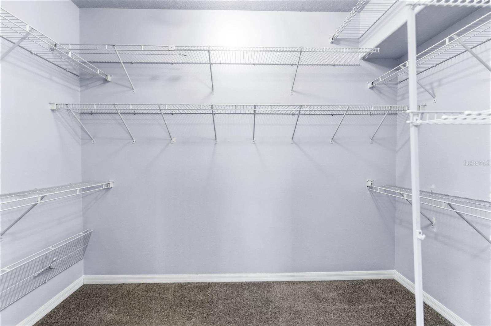 A large walk-in closet with ample space for your clothes and shoes.