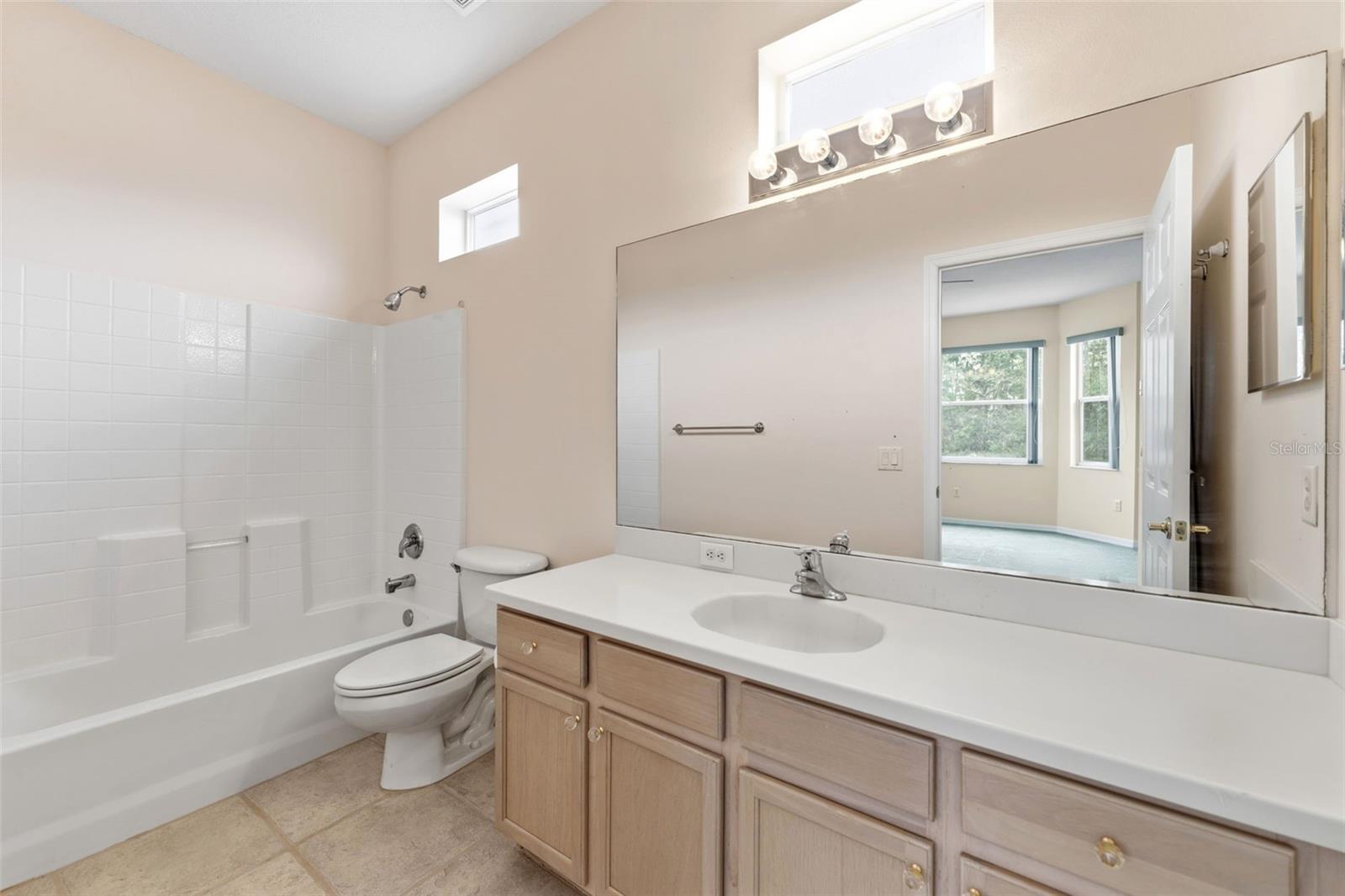 There is a single sink with extra cabinetry in the upstairs en-suite bathroom.