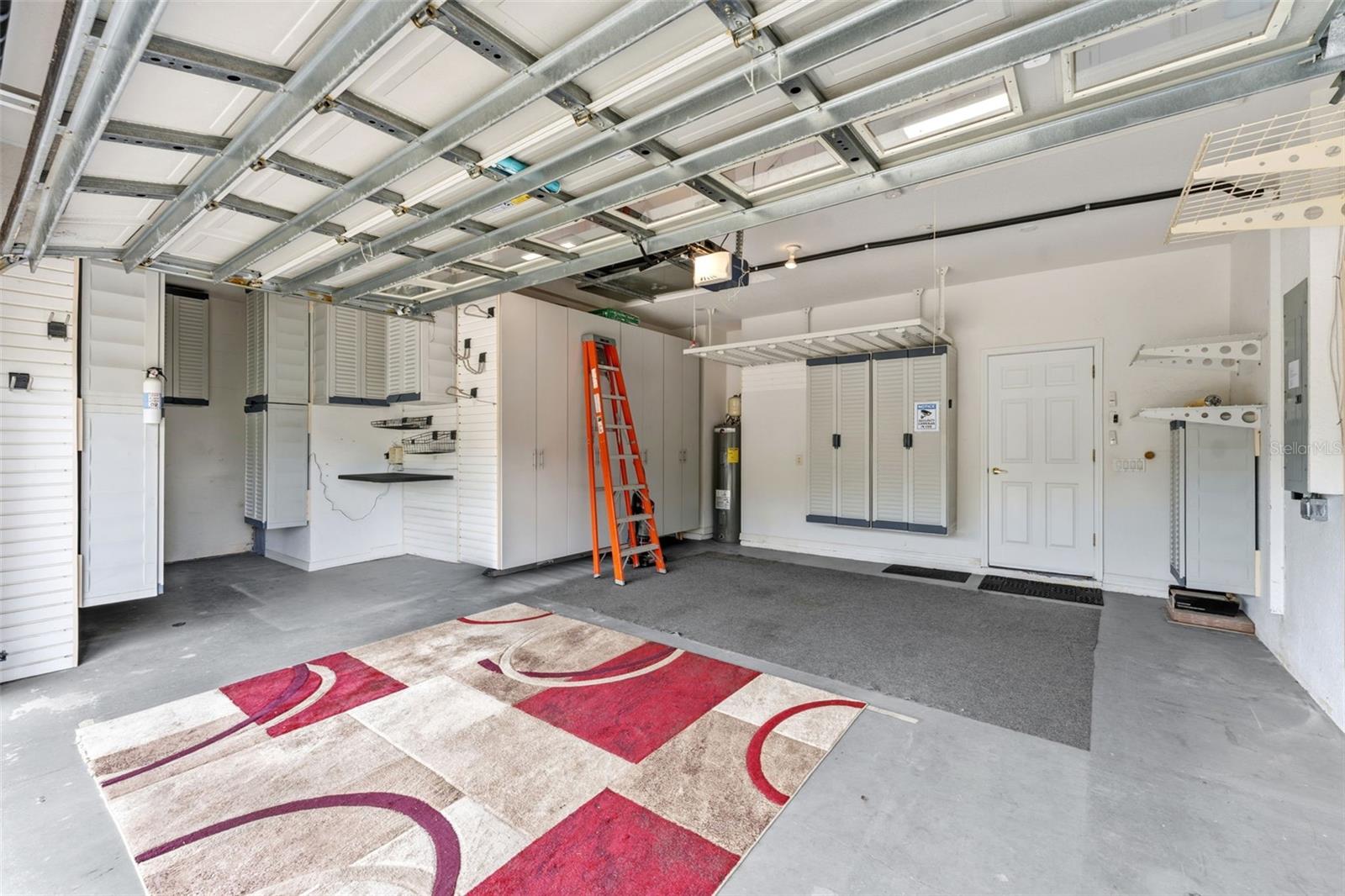 The garage has LOTS of cabinets for storage, and there is a 1/2 area for extra storage. There is also a water softener in this area.
