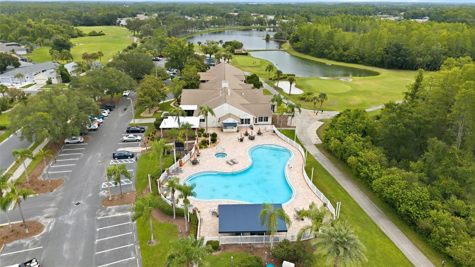The large pool area includes a spa, plenty of chairs and loungers, and a large covered area. The pool is both HEATED AND COOLED as needed.