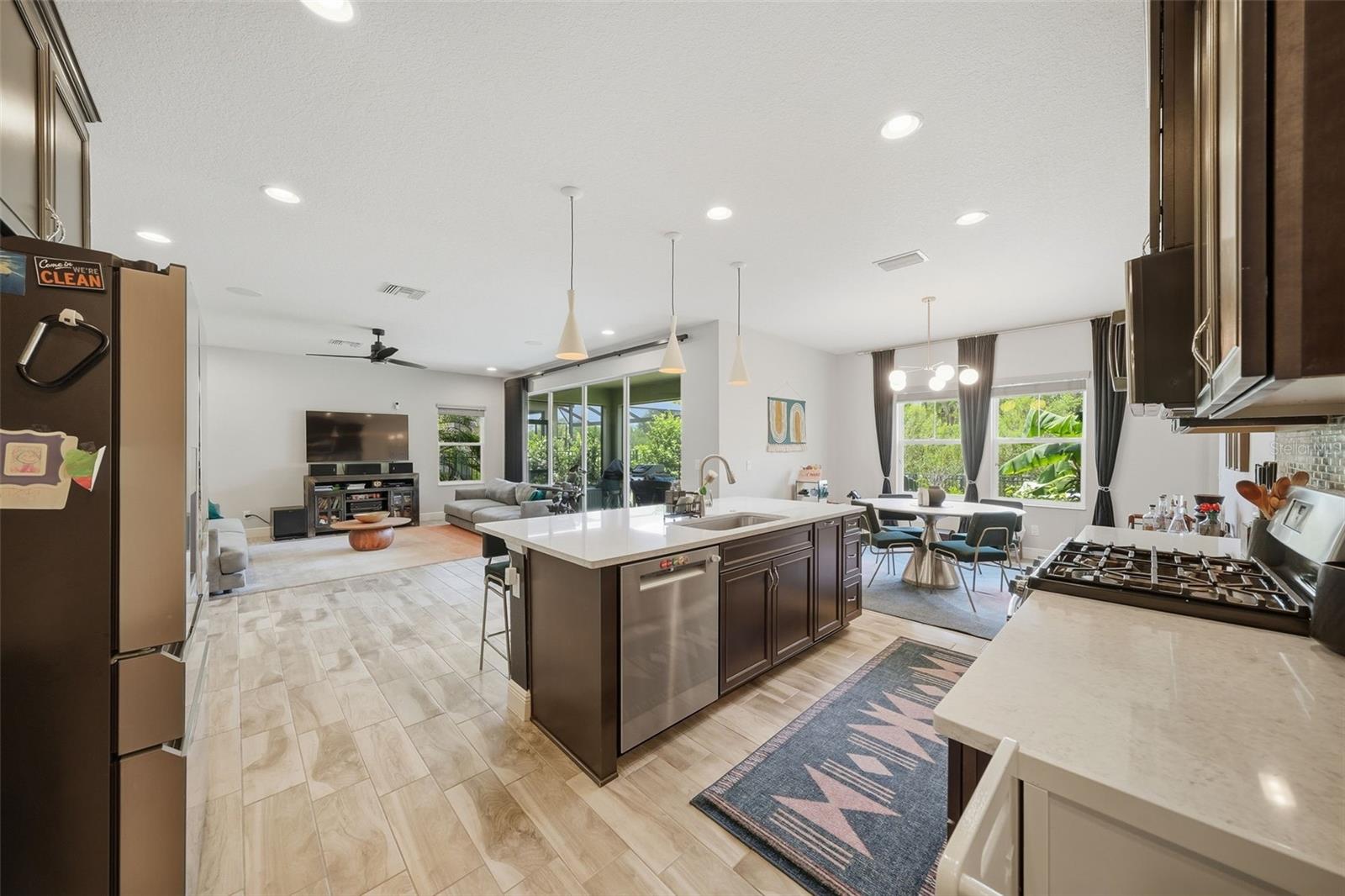 Perfect for entertaining, the kitchen opens effortlessly to the breakfast nook and spacious living room, allowing everyone to stay connected while sliding glass doors provide beautiful views and easy access to the outdoor space.